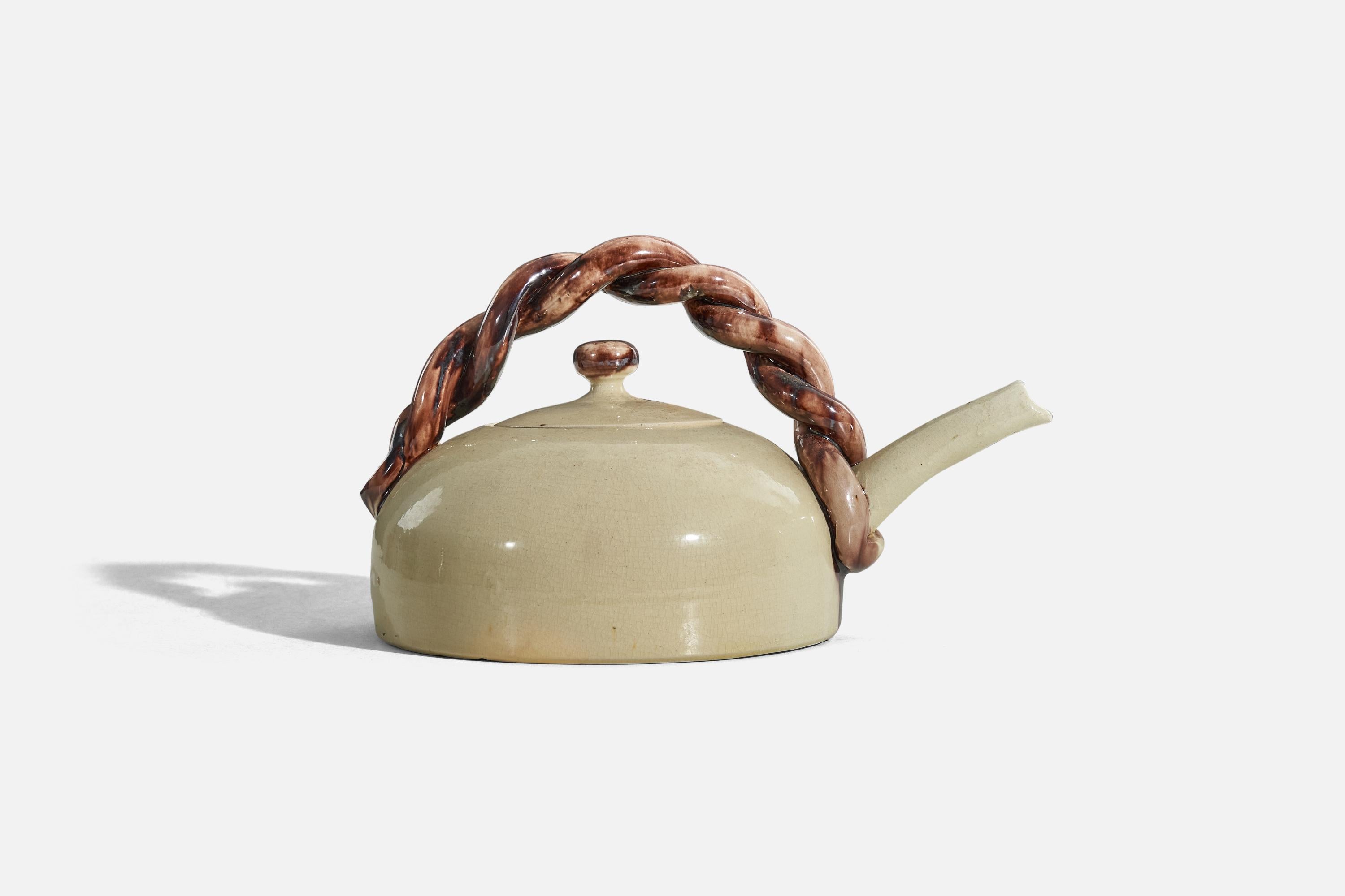 A beige and brown, glazed stoneware teapot designed and produced in Denmark, 1950s.
