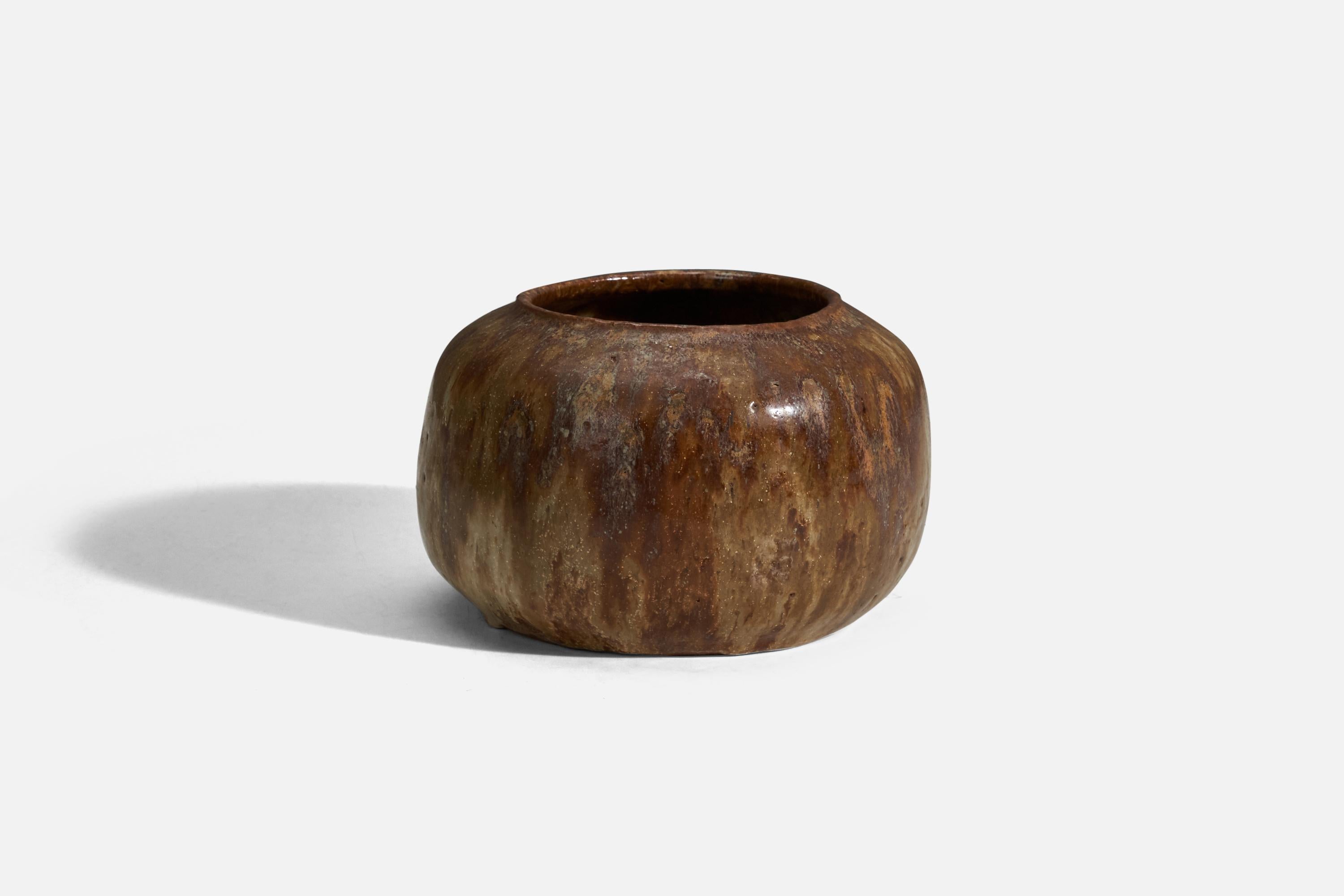 A brown glazed stoneware bowl designed and produced in Denmark, 1960s.