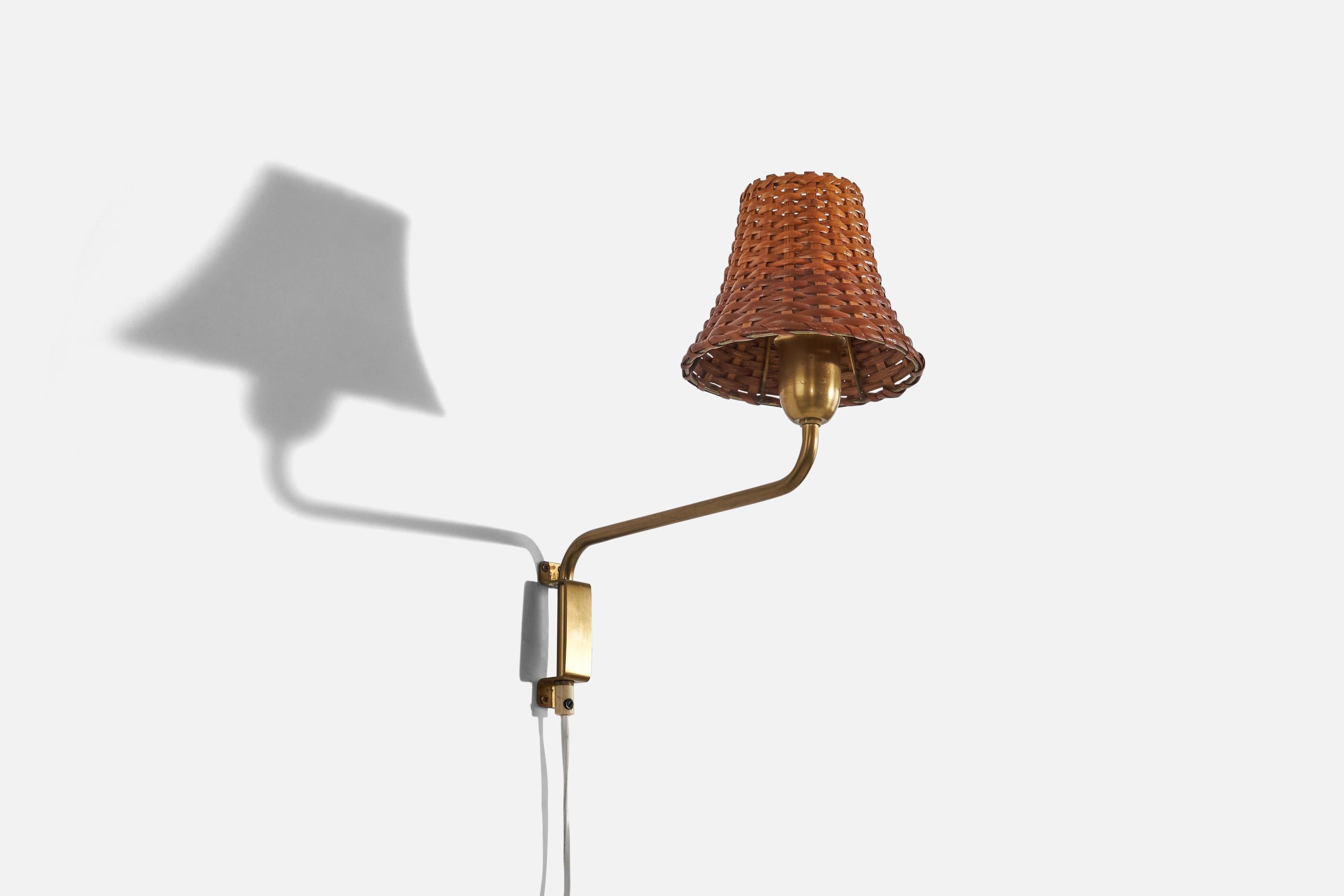 A brass and rattan wall light designed and produced in Denmark, 1940s. 

Sold with Lampshade. 
Stated dimensions refer to the lamp with the lampshade.
Dimensions of back plate (inches) : 4.12 x 1 x 1.12 (H x W x D).
 
