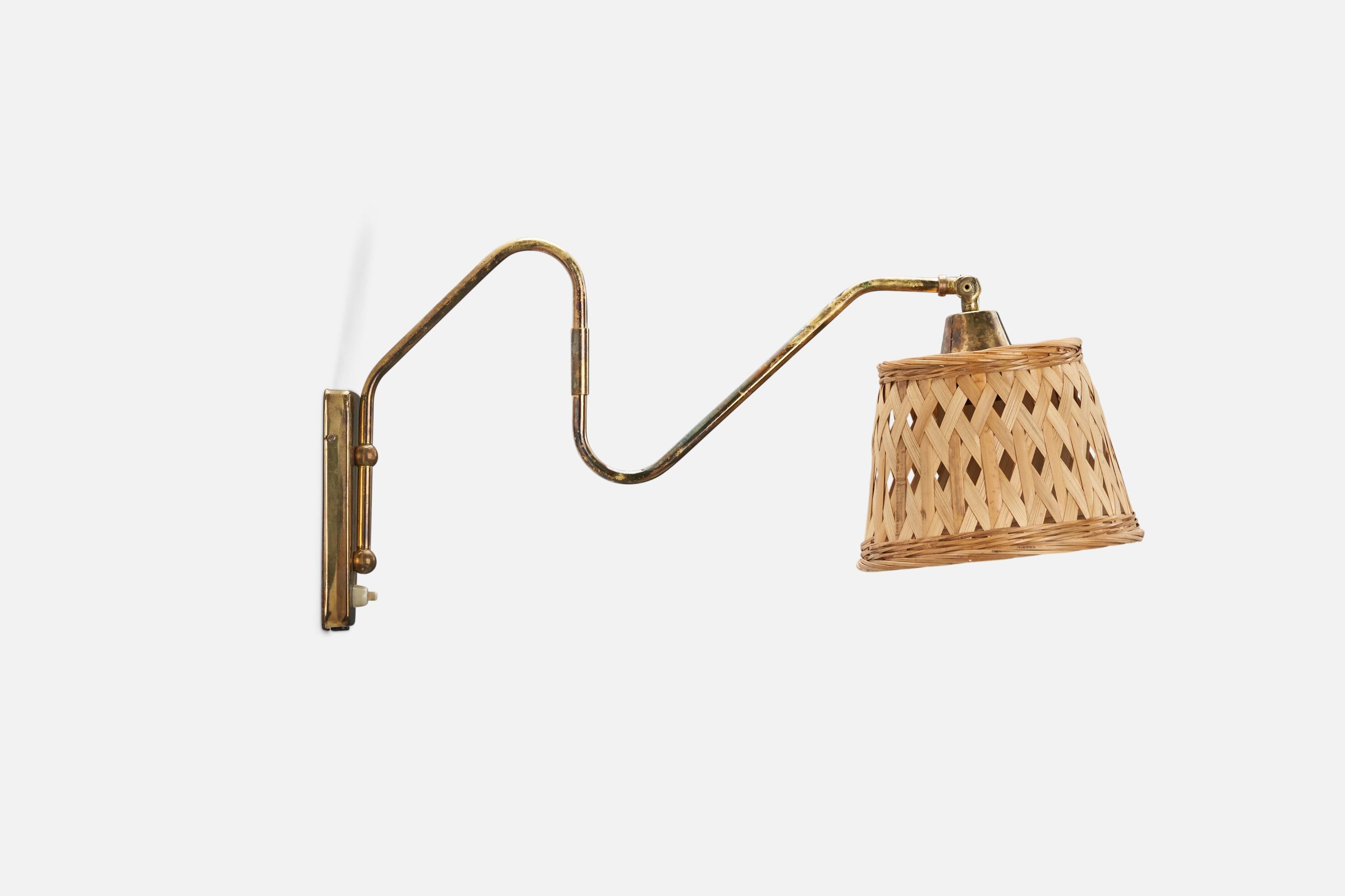 A brass and rattan wall light designed and produced by a Danish Designer, Denmark, 1940s.

Dimensions stated are of sconce with lampshade.

Dimensions variable, measured as illustrated in first image.

Dimensions of back plate (inches) : 5.98