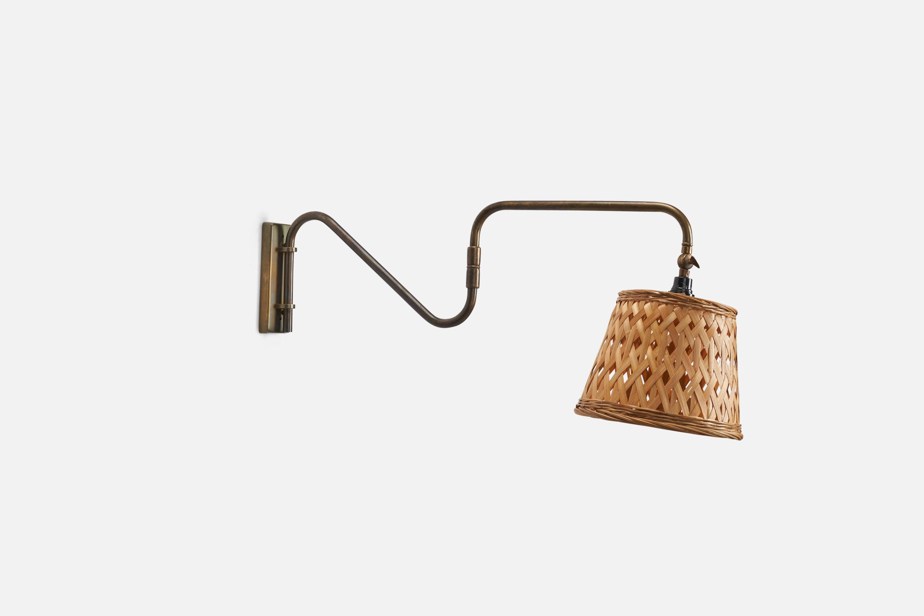 A brass and rattan designed and produced by a Danish Designer, Denmark, 1940s.

Dimensions variable, measurements listed are of sconce in its maximum extended position. 

Dimensions of Back Plate (inches) : 5.9 x 2 x 0.6 (Height x Width x