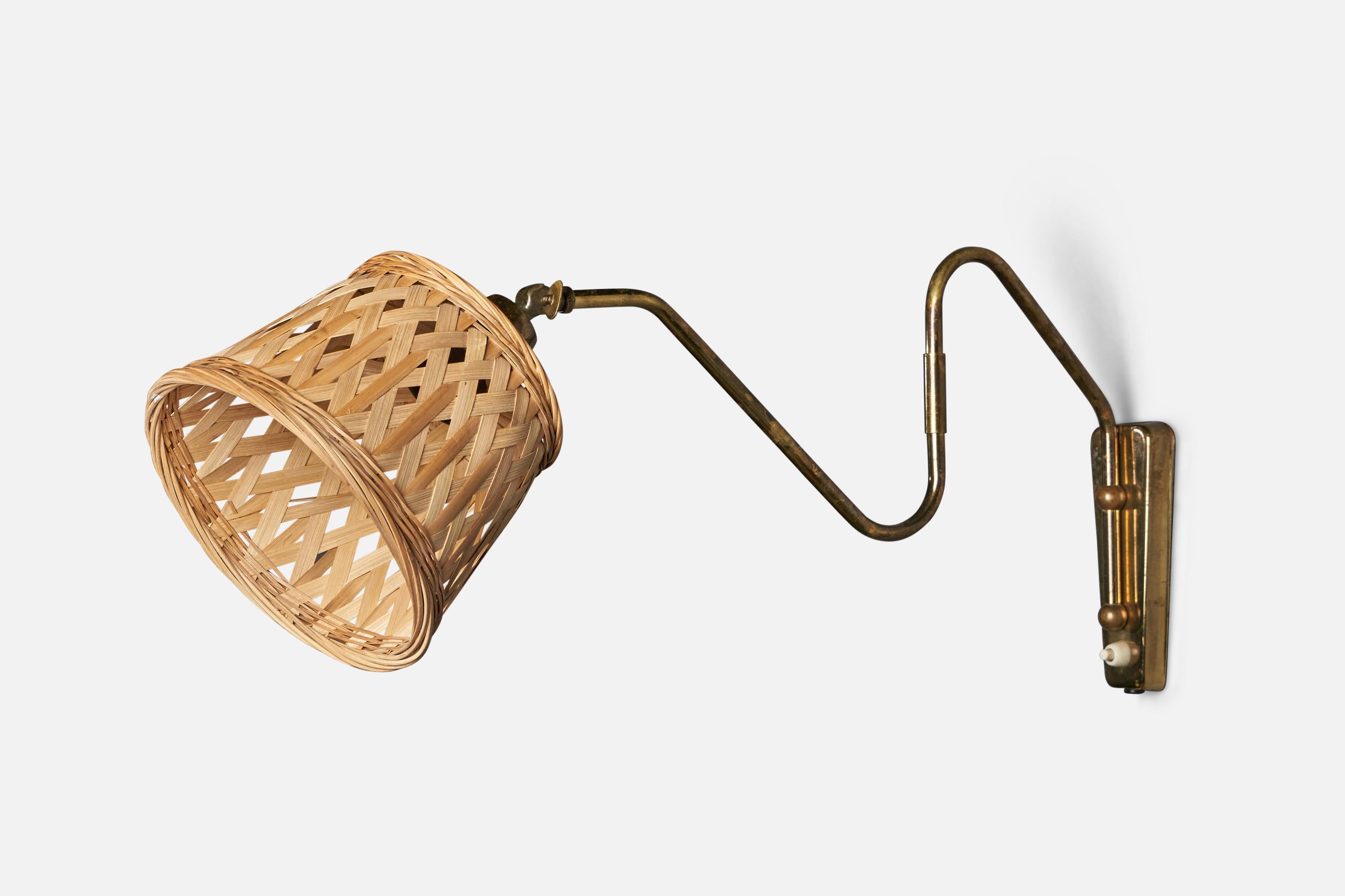 
An adjustable brass and rattan wall light designed and produced in Denmark, 1940s.
Collapsed Dimensions (inches): 10” H x 13.25” W x 7.5” D
Fully Extended Dimensions (inches): 10” H x 7” W x 20” D 
Back Plate Dimensions (inches): 6” H x 2.25” W x