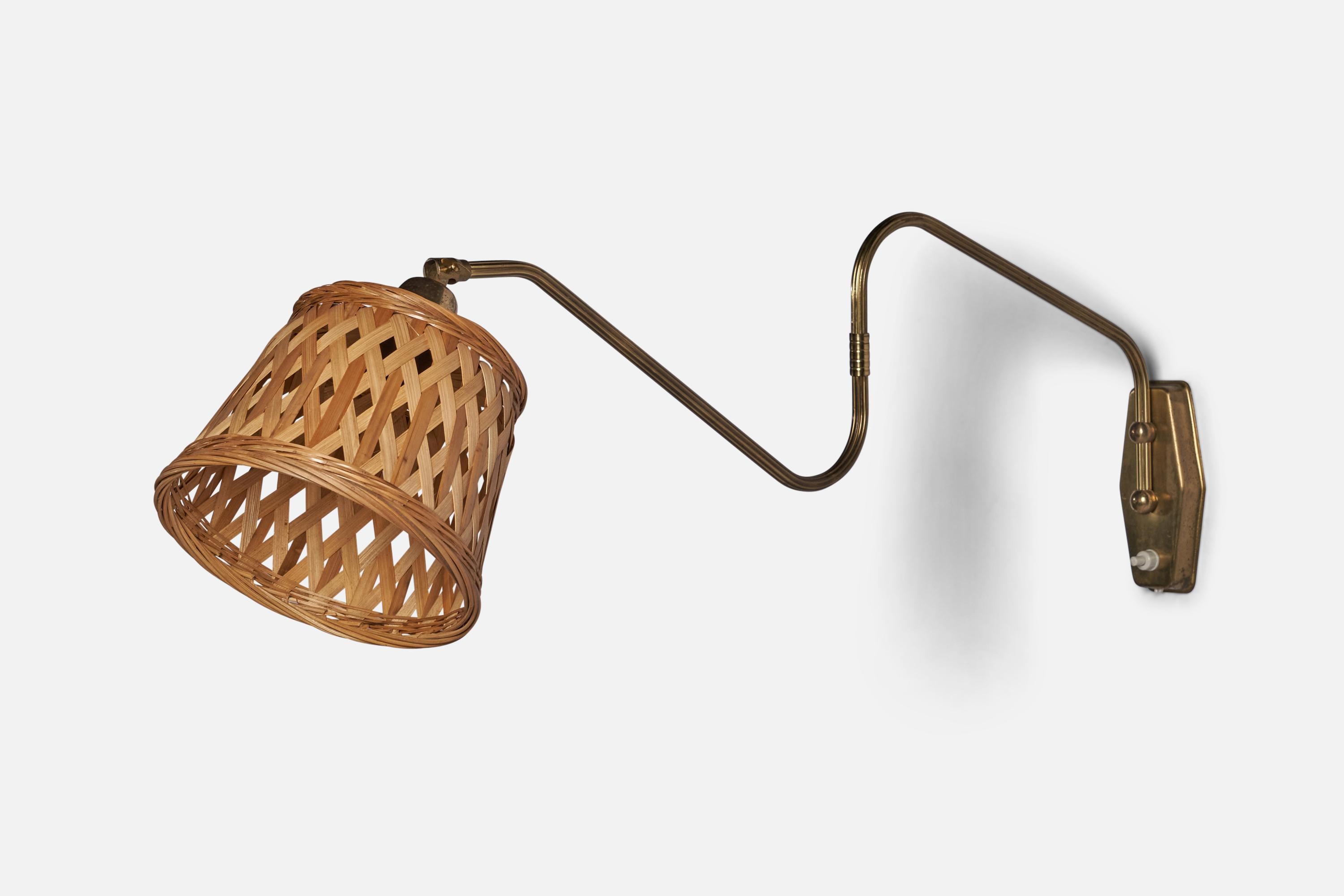An adjustable brass and rattan wall light designed and produced in Denmark, 1940s.

Overall Dimensions (inches): 15” H x 7” W x 29” D
Back Plate Dimensions (inches): 5.25” H x 2.5” W 
Bulb Specifications: E-26 Bulb
Number of Sockets: 1
All lighting