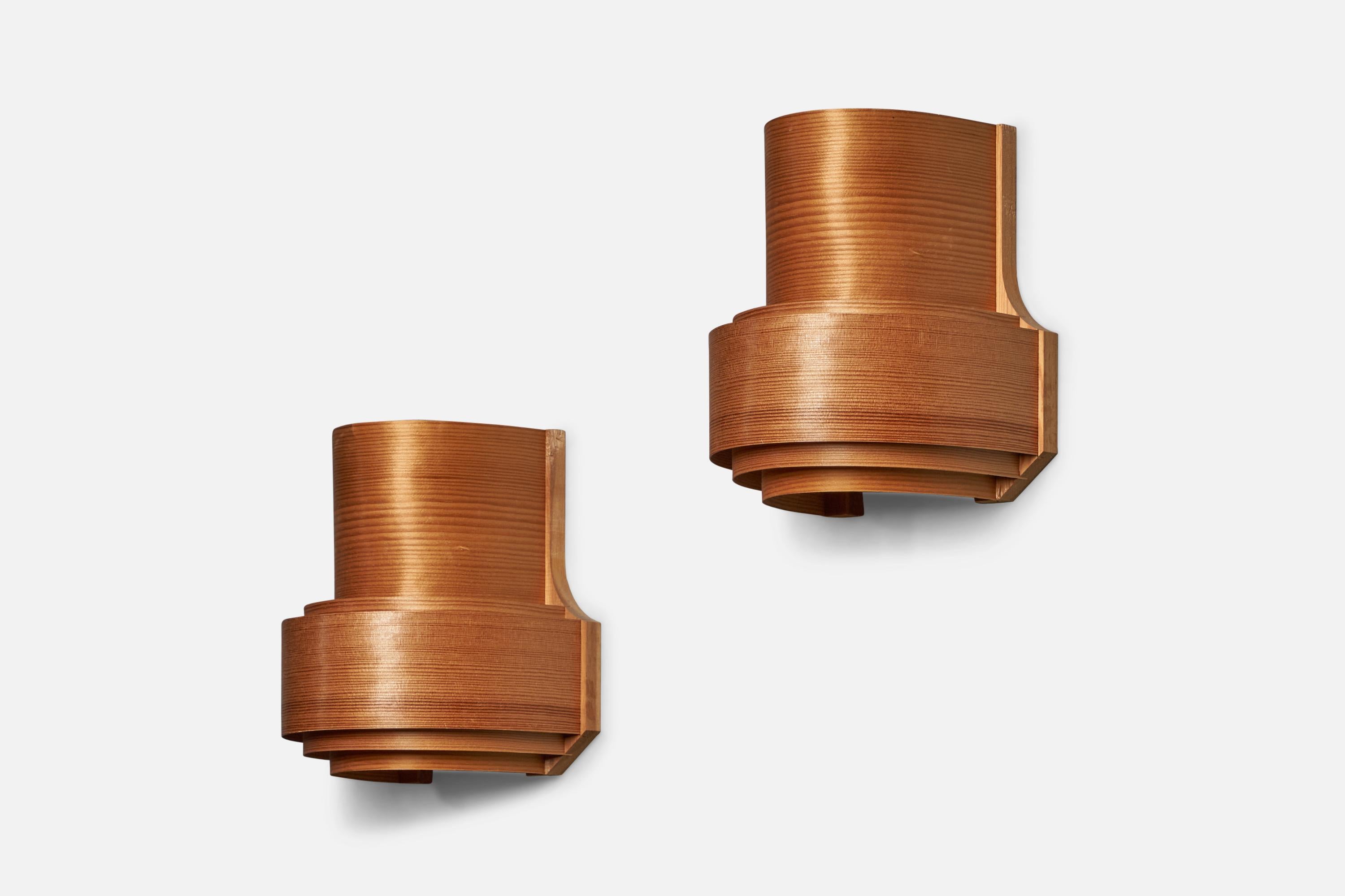 A pair of pine and moulded pine veneer wall lights designed and produced in Denmark, 1970s.

Overall Dimensions (inches): 9” H x 8.5” W x 6.5” D
Bulb Specifications: E-26 Bulb
Number of Sockets: 1
Minor breaks to veneer