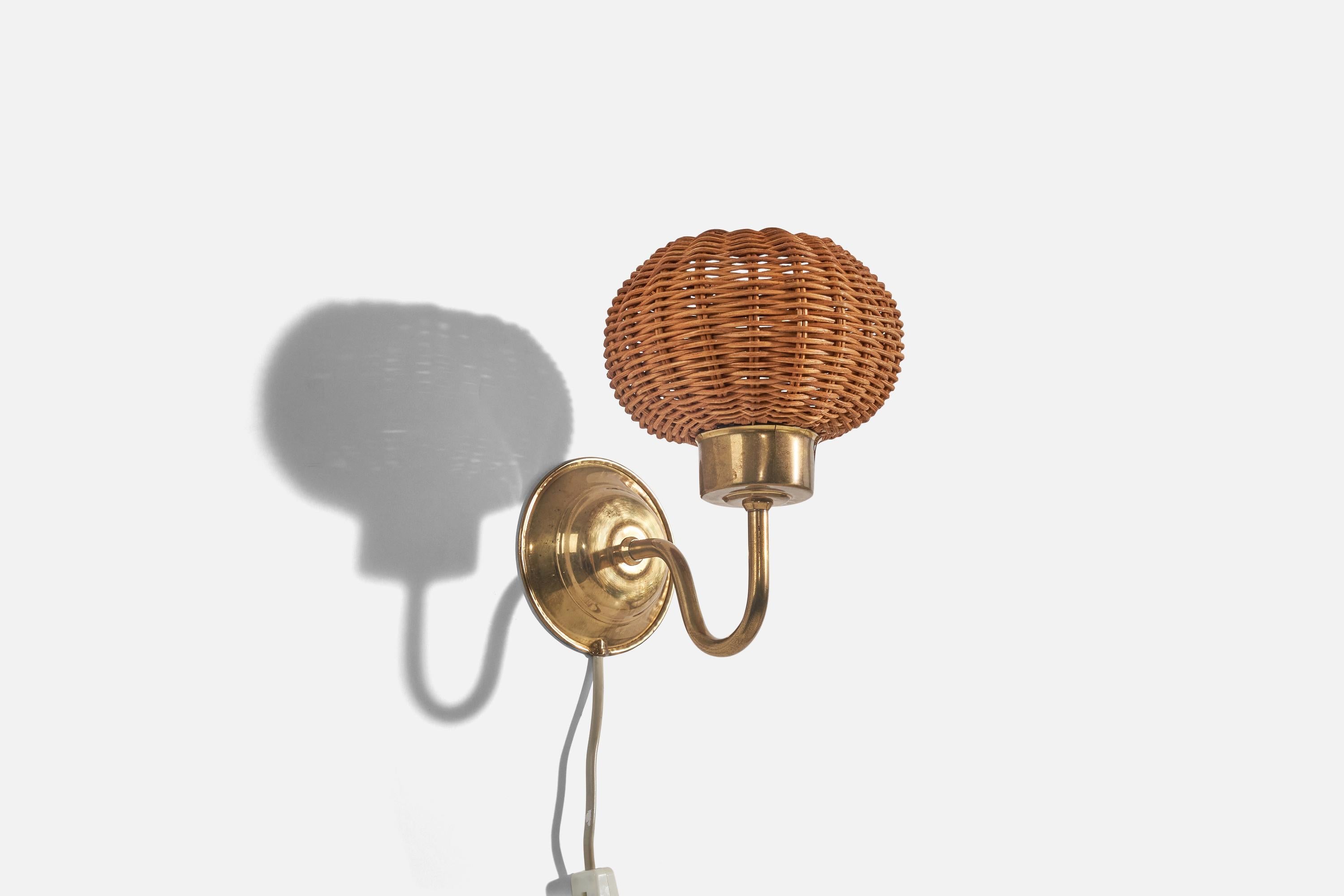 A pair of brass and rattan wall lights designed and produced in Denmark, c. 1960s. 

Dimensions of back plate (inches) : (4.06 x 4.06 x 1.25).