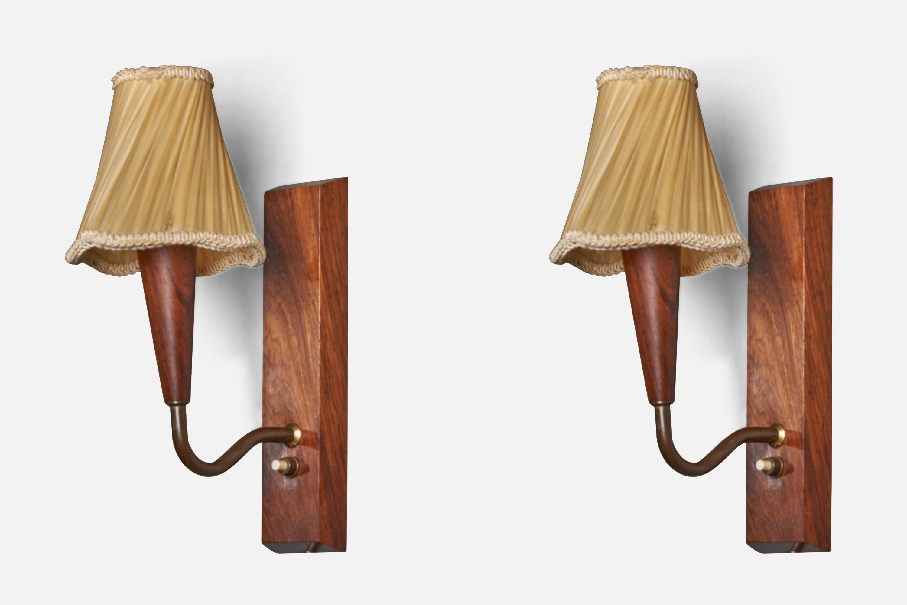 A pair of teak, brass and yellow fabric wall lights designed and produced in Denmark, c. 1940s.

Overall Dimensions (inches): 11” H x 4.5” W x 6.75” D
Bulb Specifications: E-14 Bulb
Number of Sockets: 1

