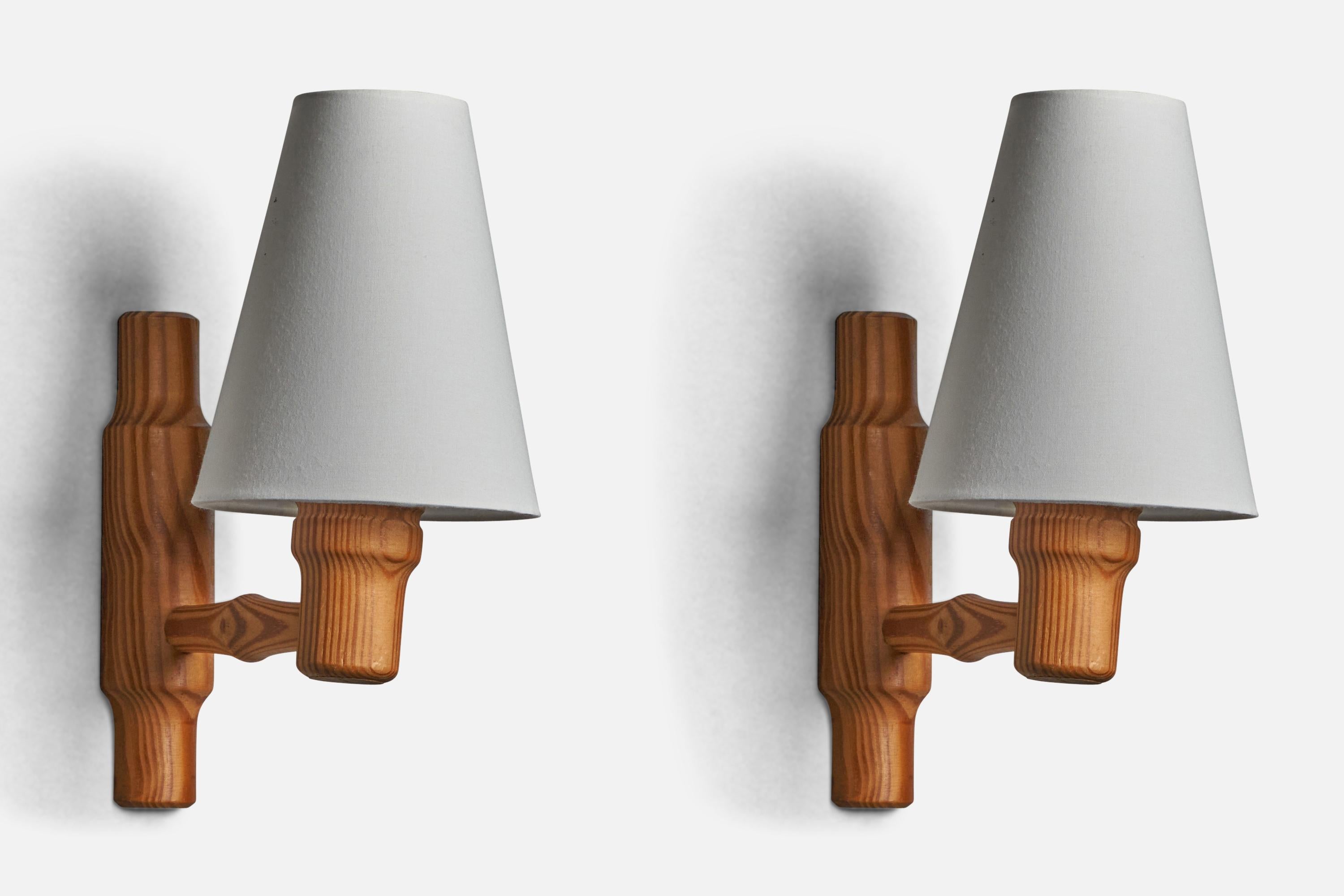 A pair of pine and white fabric wall lights designed and produced in Denmark, c. 1970s.

Overall Dimensions (inches): 11.5” H x 5.5” W x 8.5” D
Back Plate Dimensions (inches): 8.3” H x 2” W x 1” D
Bulb Specifications: E-14 Bulb
Number of Sockets: 1