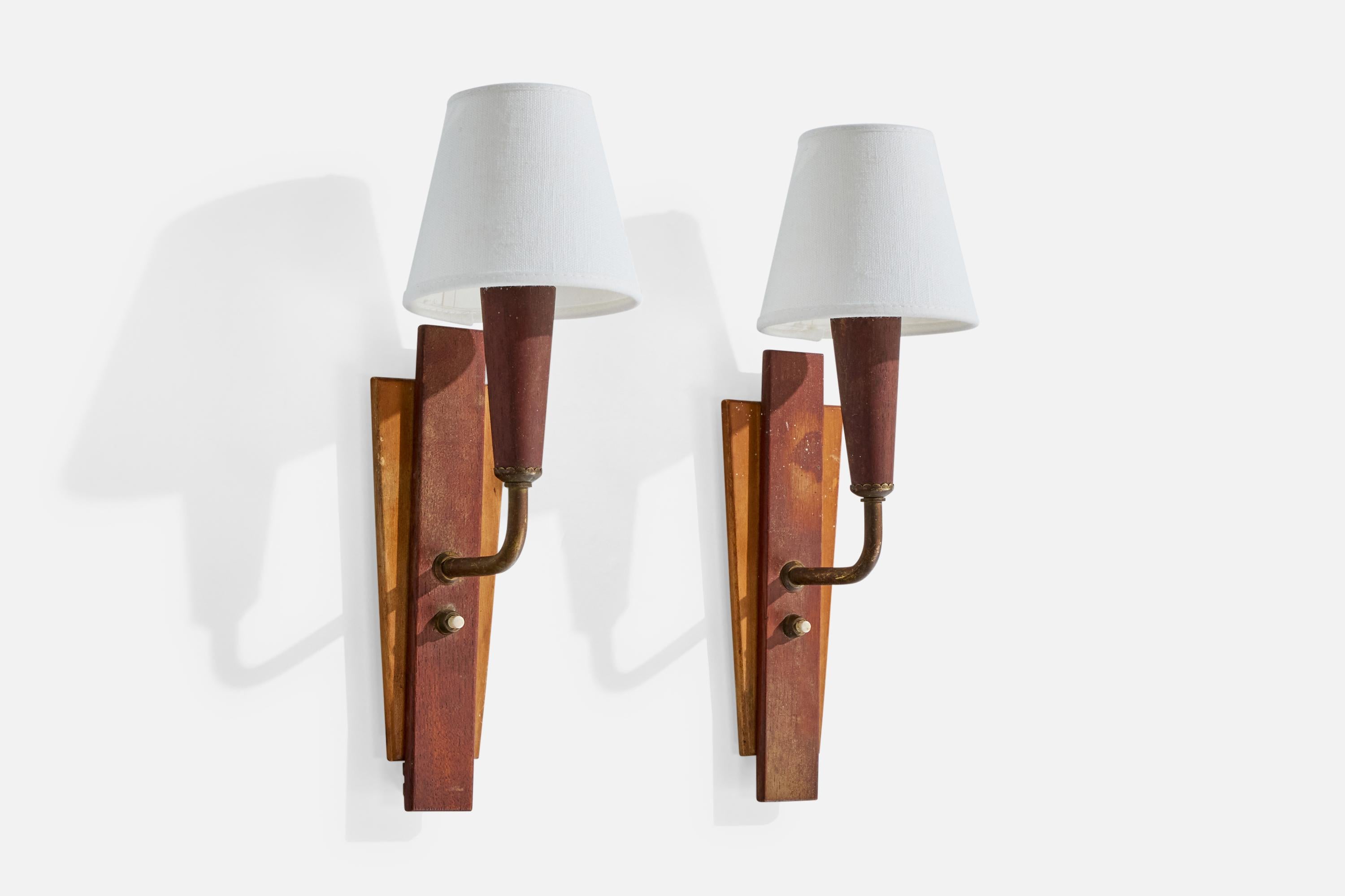 A pair of teak, brass and white fabric wall lights designed and produced in Denmark, c. 1950s.

Overall Dimensions (Inches): 13.25