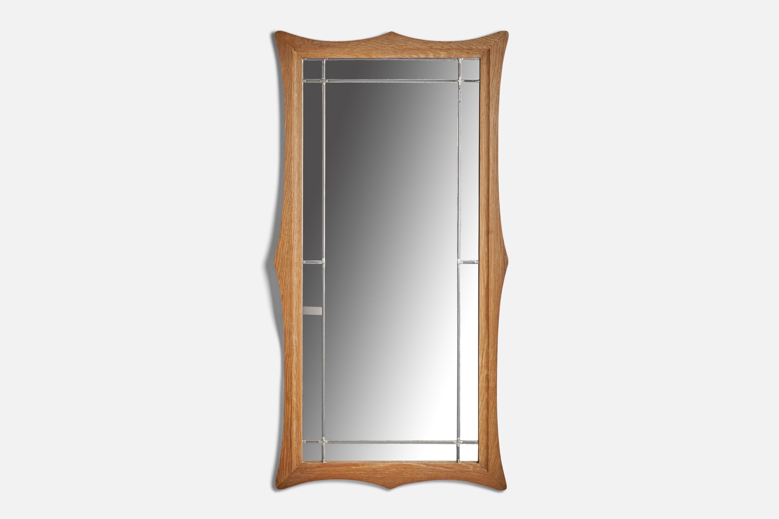 An oak and pewter wall mirror designed and produced in Denmark, c. 1960s.