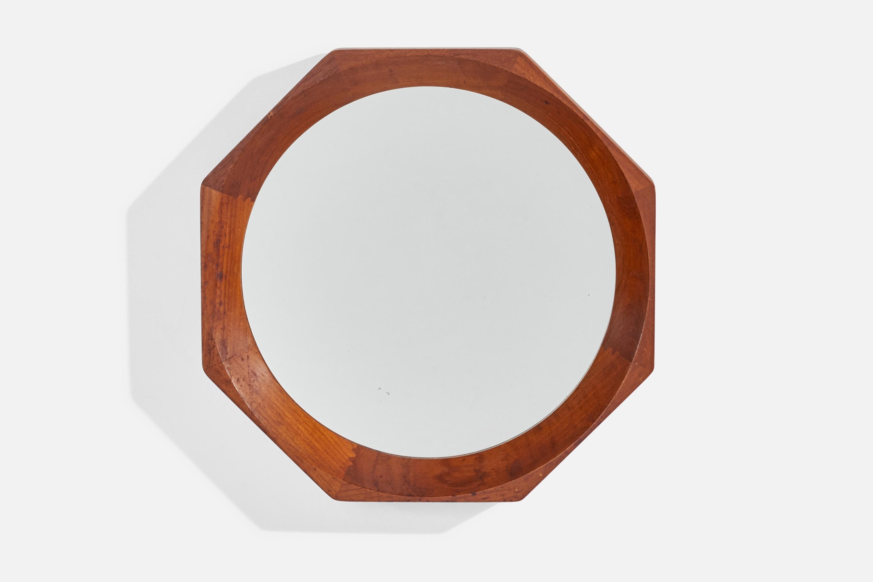 An octagonal teak wall mirror designed and produced in Denmark, c. 1950s.