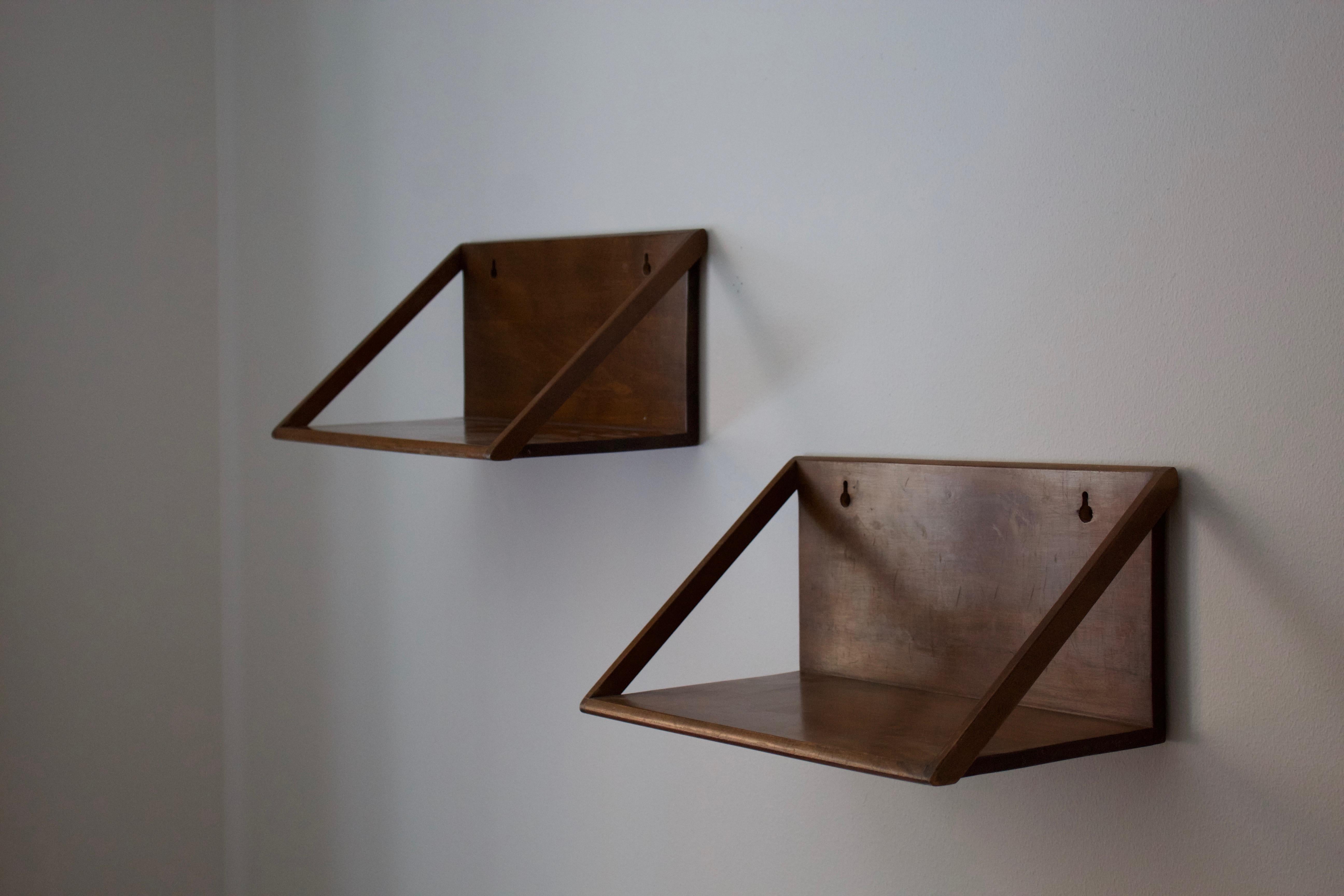 A pair of minimalist wall shelves / nightstands. Designed and produced in Denmark, 1950s.

Other designers of period include Axel Einar Hjorth, Pierre Jeanneret, Franco Albini, Alvar Aalto, and Kaare Klint.