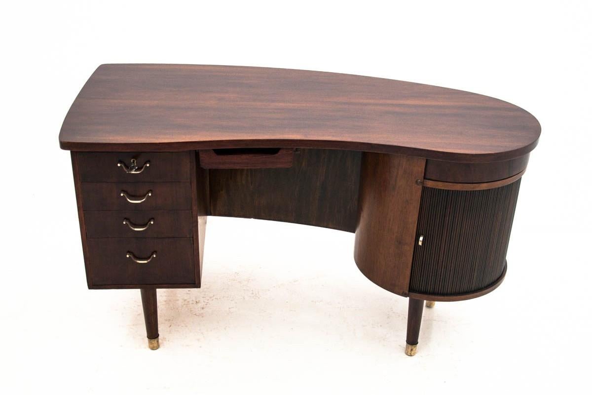 The desk comes from Denmark from the 1960s and 1970s. 
Classic Danish design. Attributed to Kai Kristiansen design.
Front with three drawers and mini bar behind the sliding doors.
 Very good condition.

 