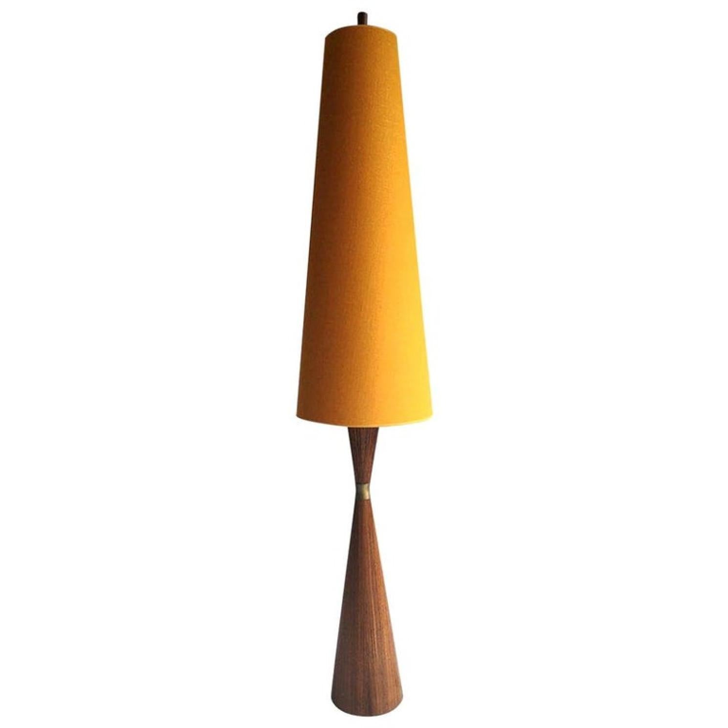 This rare modern teak diablo floor lamp was designed in the 1960s. The base is weighted for a sturdy. Very elegant and unusual. A copper cuff sits in the center. The new upholstered linen shade provides a warm glow.

In very good vintage condition.

