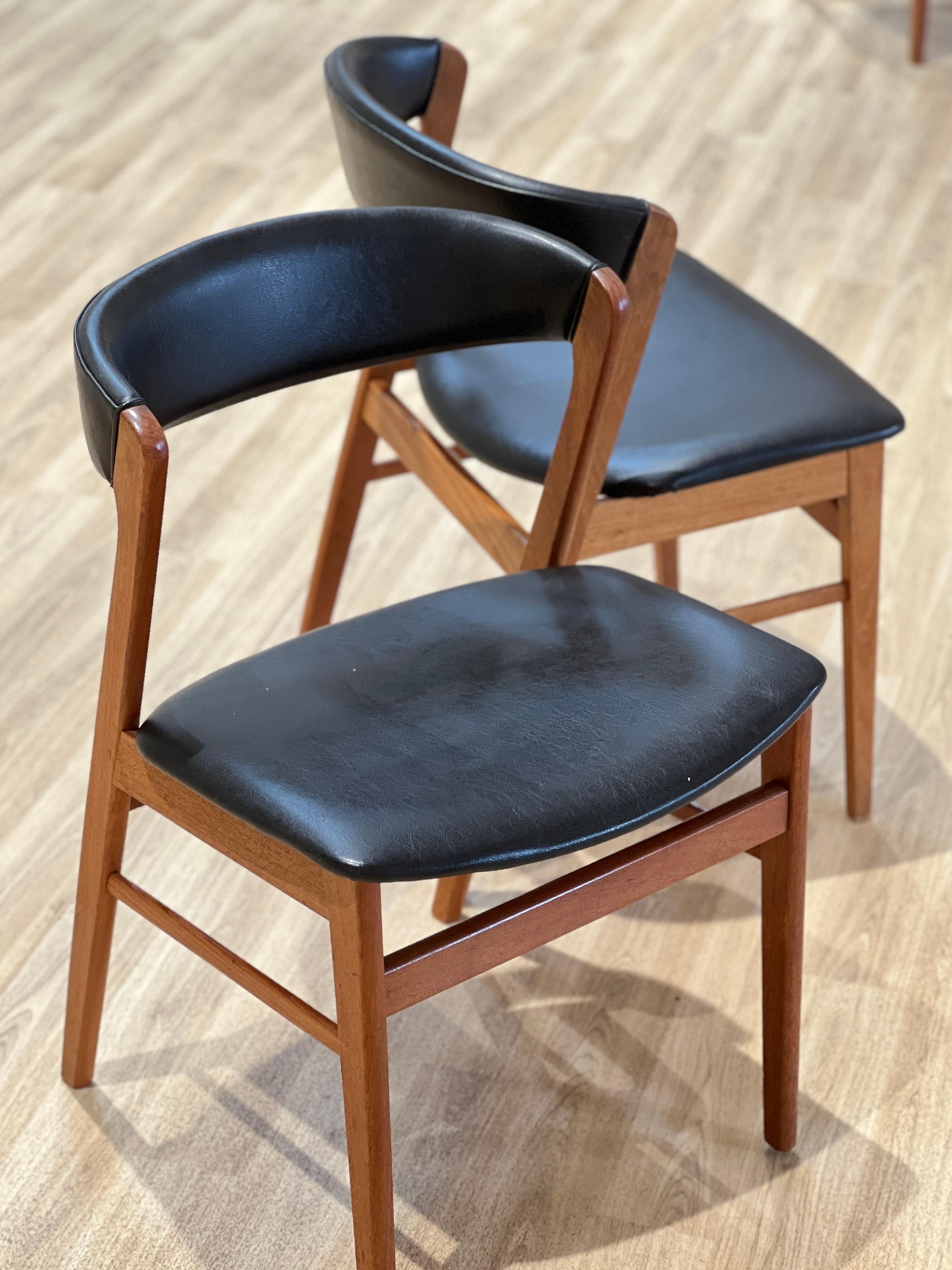 This is a beautiful set of six Danish chairs that are skillfully crafted using high-quality teak wood, renowned for its durability and resistance to decay. These chairs are not only sturdy but also adorned with black leatherette upholstery, which