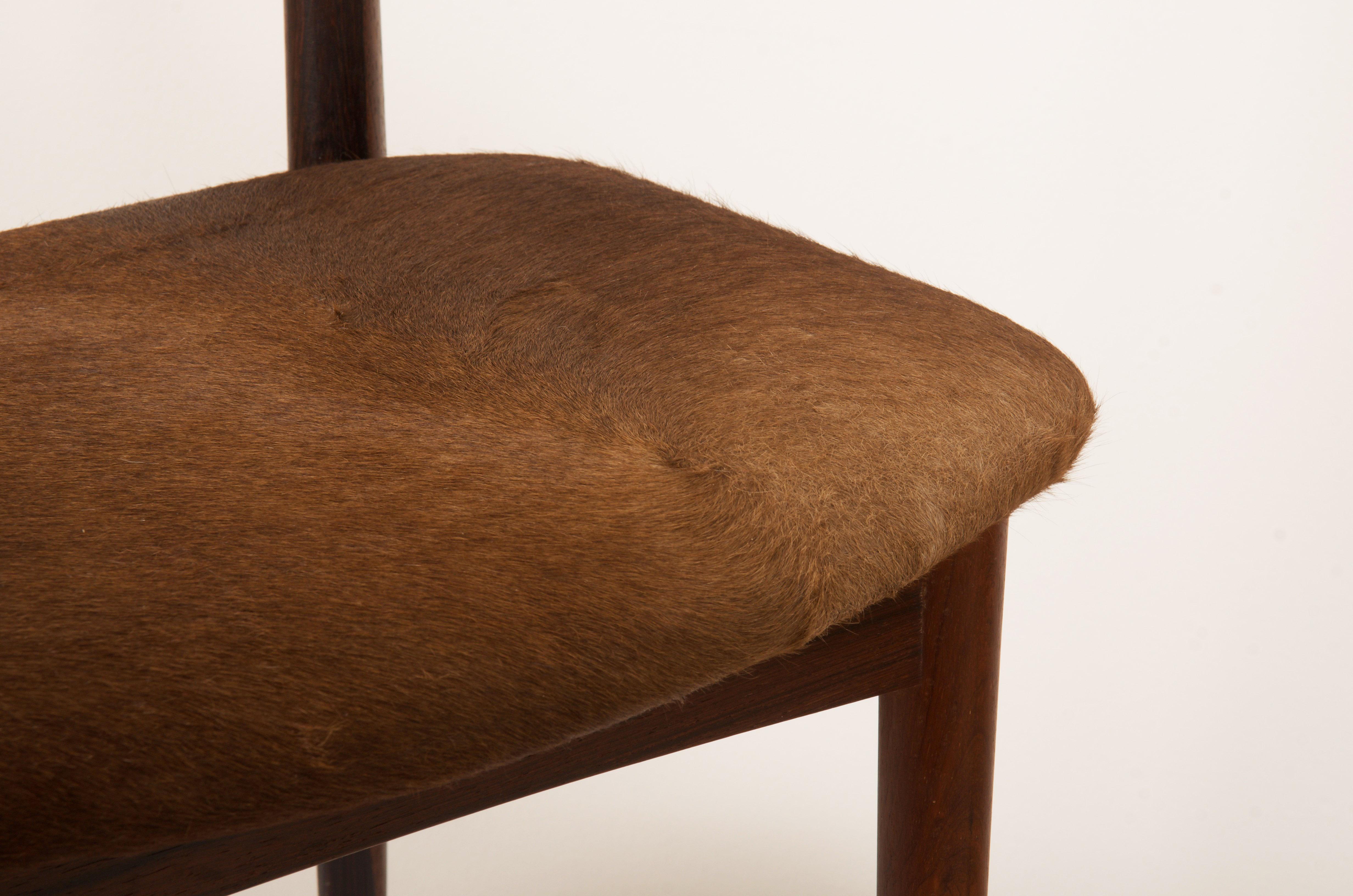 Cowhorn style hardwood dining chair designed by Helge Sibast and Borge Rammeskov for Sibast Mobler, circa 1960s. Elegant carved backs with brass mountings upholstered with brown cowhide.