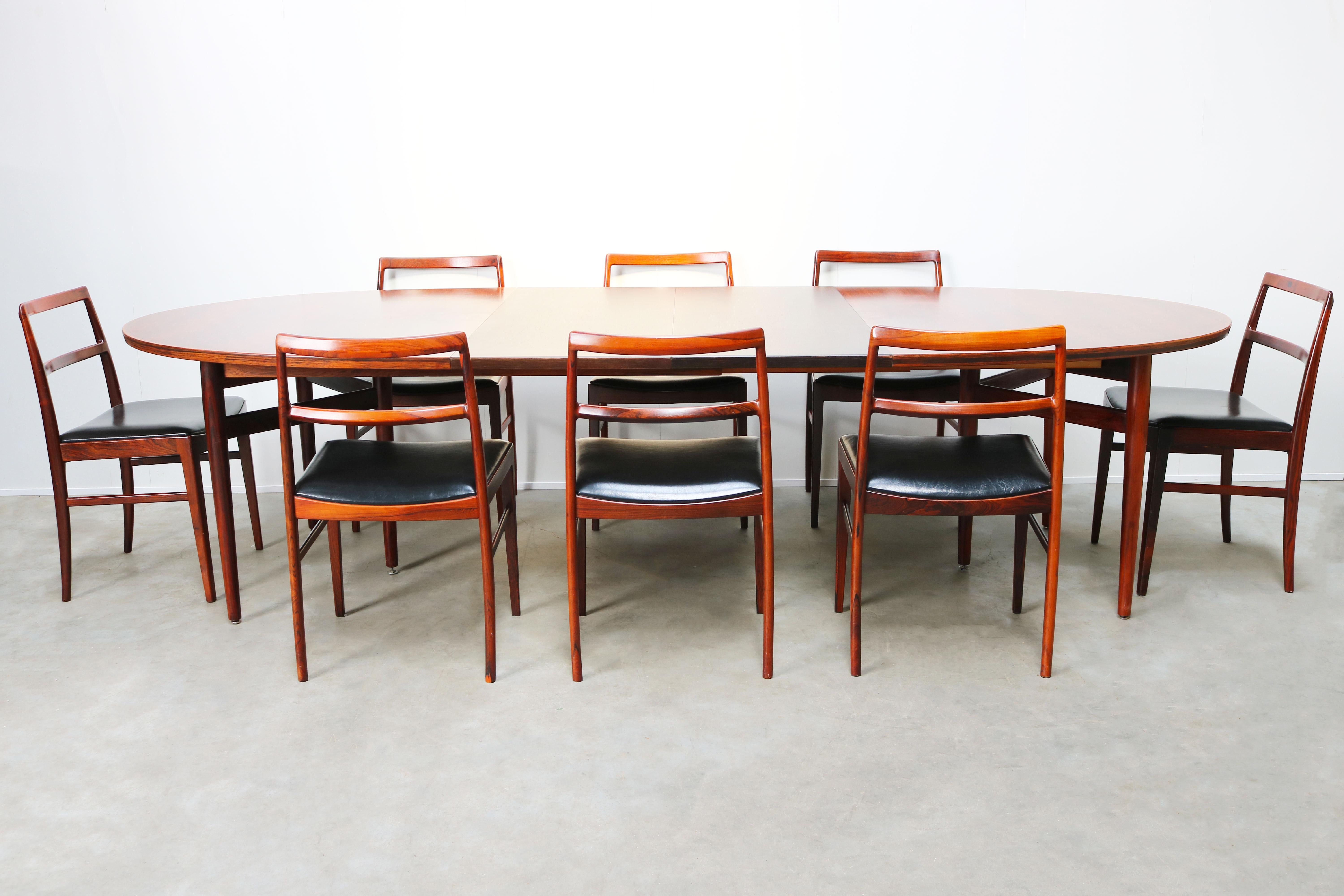 Wonderful and very rare complete dining room set by famous Danish designer: Arne Vodder for Sibast Mobelfabrik in the 1950s. The set conists of eigth Model: 430 dining chairs in rosewood with black leather upholstery and a matching Model: 212 oval