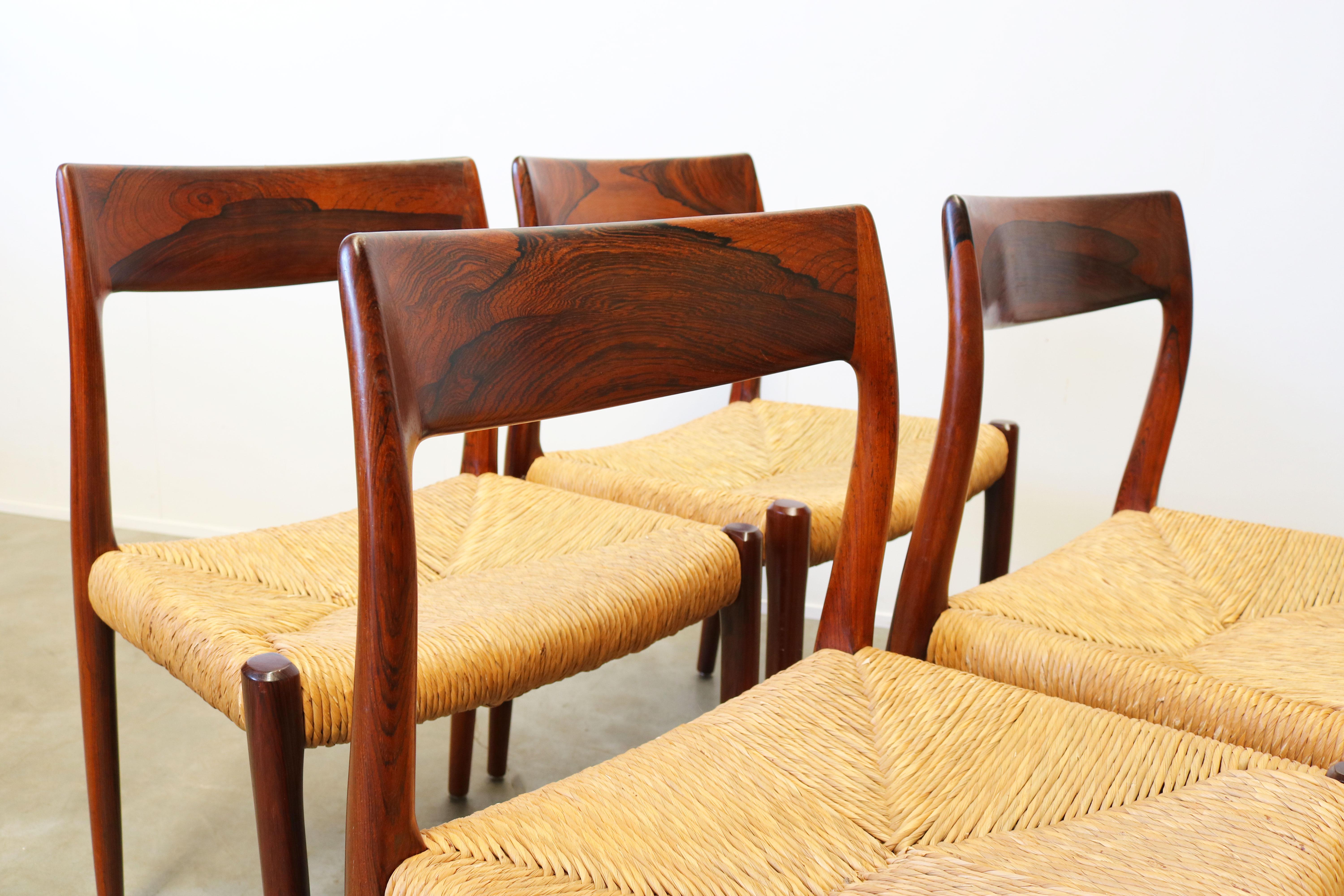 Wonderful Danish dining room set by Niels Otto Moller produced by J.L. Mollers Mobelfabrik in the 1950s. The set consists of four model. 77 chairs in solid sculpted rosewood and rattan seats and a matching original solid rosewood (extendable) dining