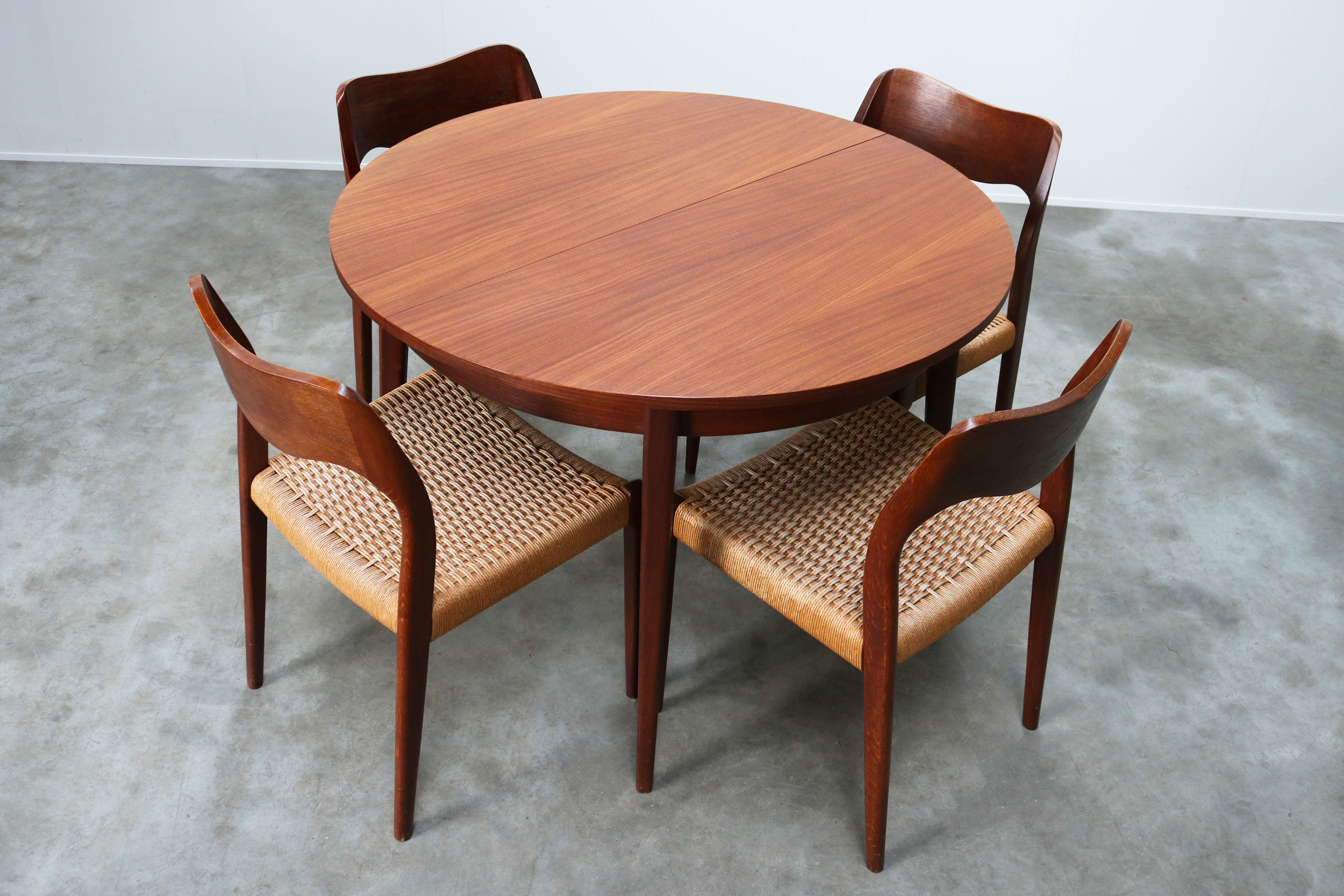 Magnificent Danish dining room set by Niels Otto Moller for JL Moller Mobelfabrik, 1950. The set consists of four teak and papercord model.71 chairs and a matching round teak table (extendable). Set is in wonderful original condition, small traces