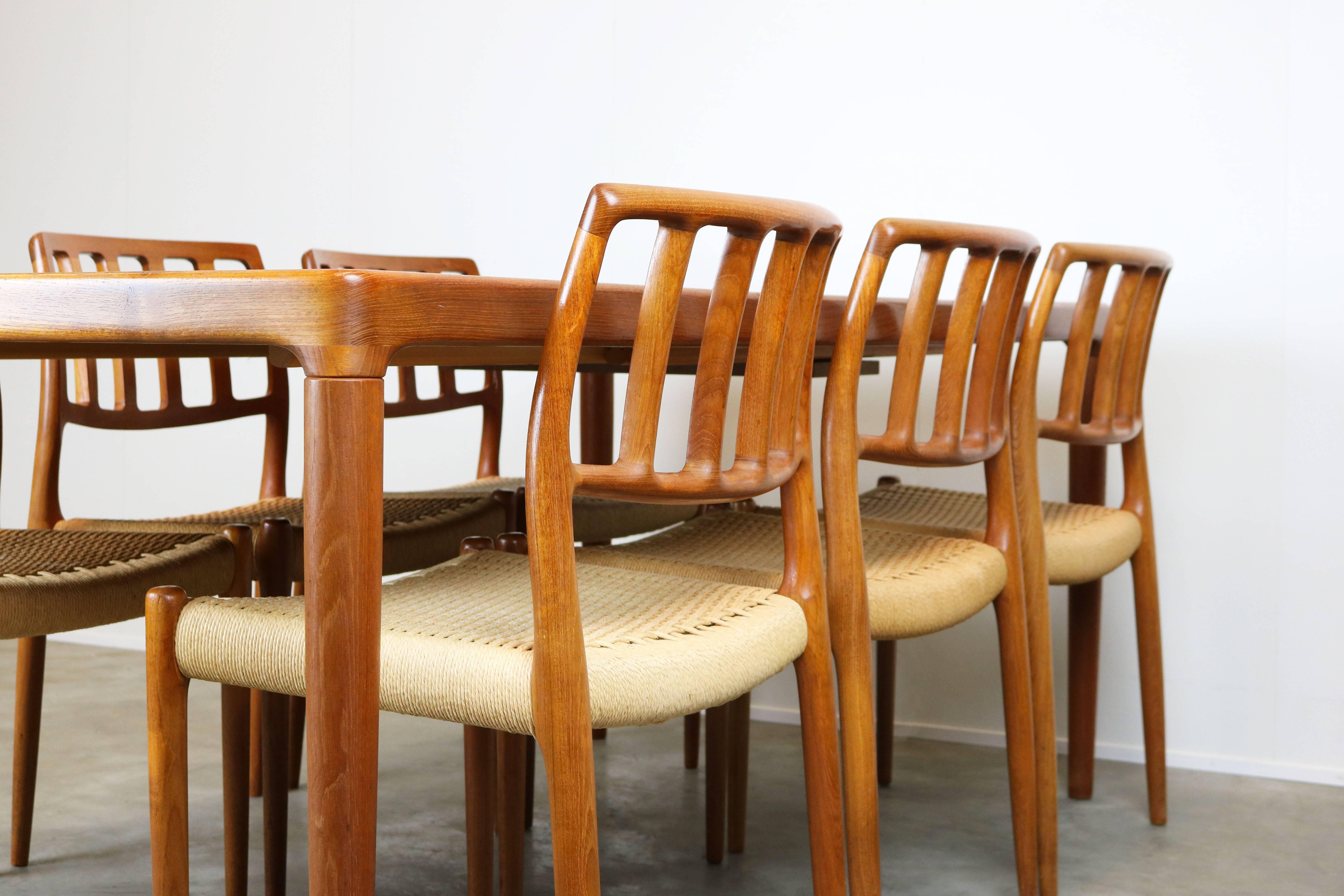 Magnificent Danish dining room set by Niels Otto Moller for JL Moller Mobelfabrik, 1960. The set consists of six teak and papercord model.83 chairs and original matching teak table (extendable). Set is in wonderfull original condition. A perfect set