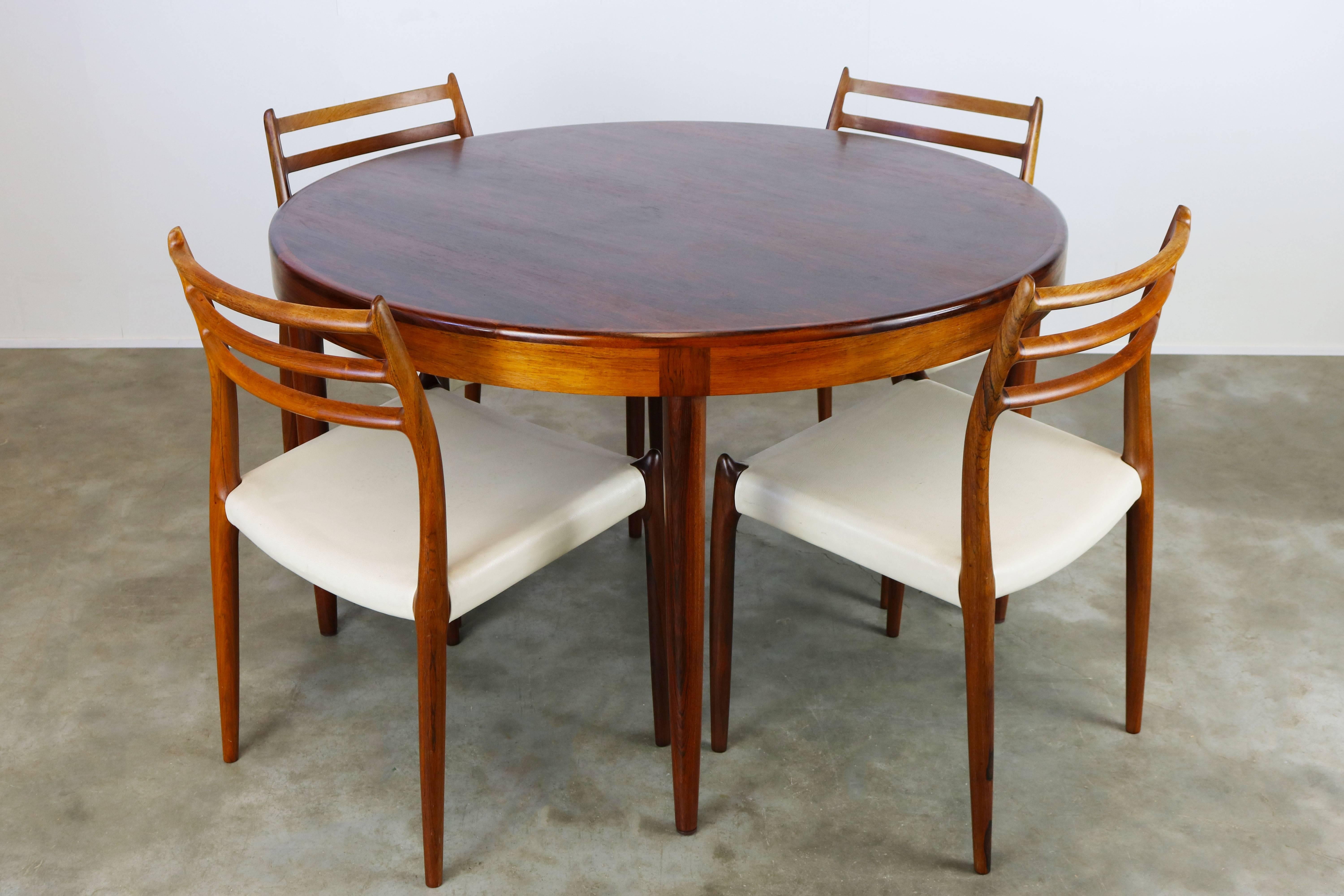 Magnificent Danish dining room set by Niels Otto Møller for JL Moller Mobelfabrik, 1950 in solid Rosewood. The set consists of four rosewood and white leather model.78 chairs and original matching round rosewood table. Set is in wonderful original
