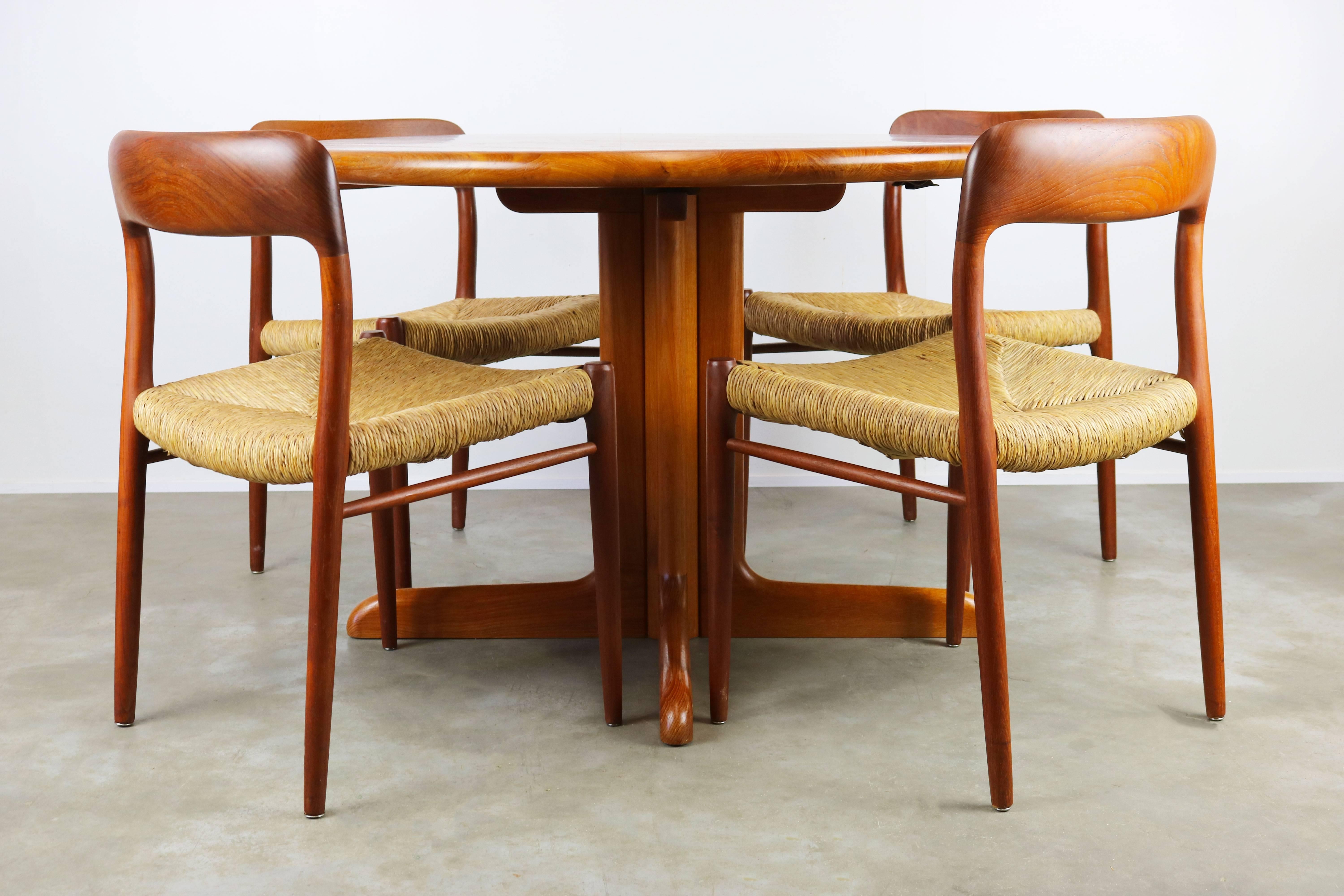 Magnificent Danish design dining room set Designed by Niels Otto Moller and produced by the J.L Mollers Mobelfabrik in the 1950s. The set consists of four solid teak model 75 chairs with handwoven rare Rattan seats and a matching round solid teak