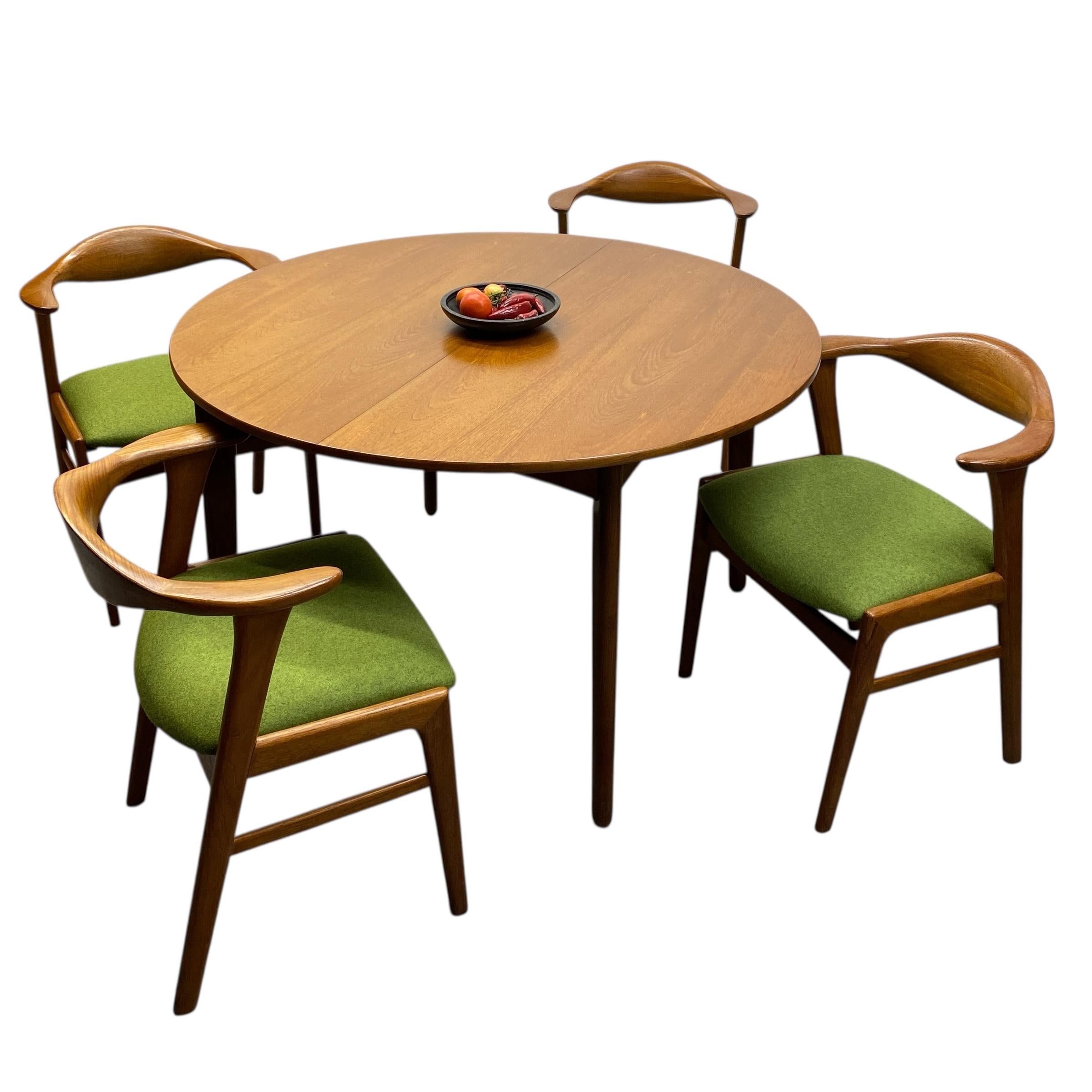 A fabulous dining set of four midcentury Danish Erik Kirkegaard dining chairs, model 49 & a beautiful teak Danish dining table. The teak dining chairs are a beautiful shape, curved & reupholstered in green Yorkshire Camira. The dining table is