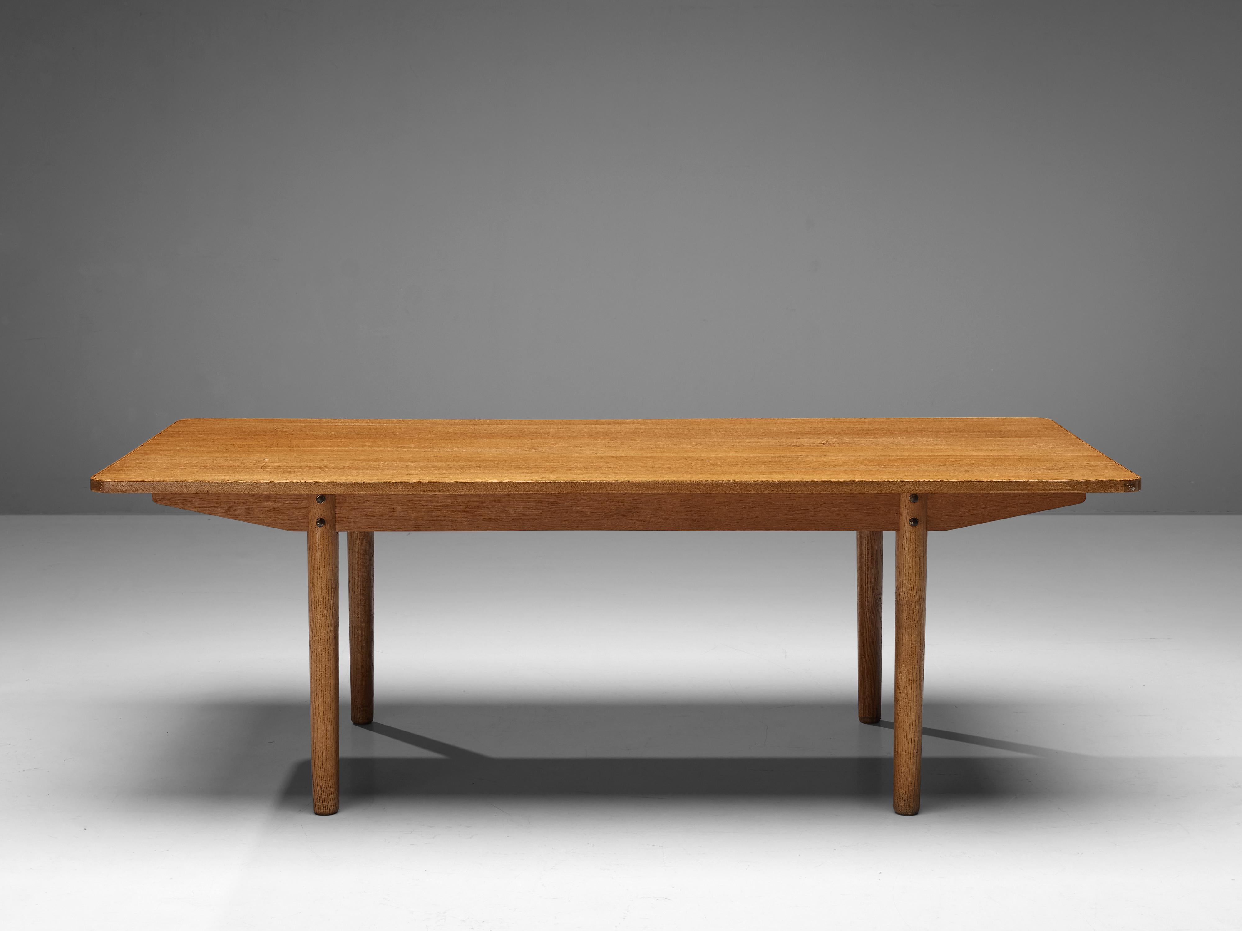 Dining table, oak, Denmark, 1960s 

This Danish dining table features a long, rectangular top executed in oak. The warm table top has beautiful soft edges and rests on four circular legs, which makes this particular table a wonderful example of