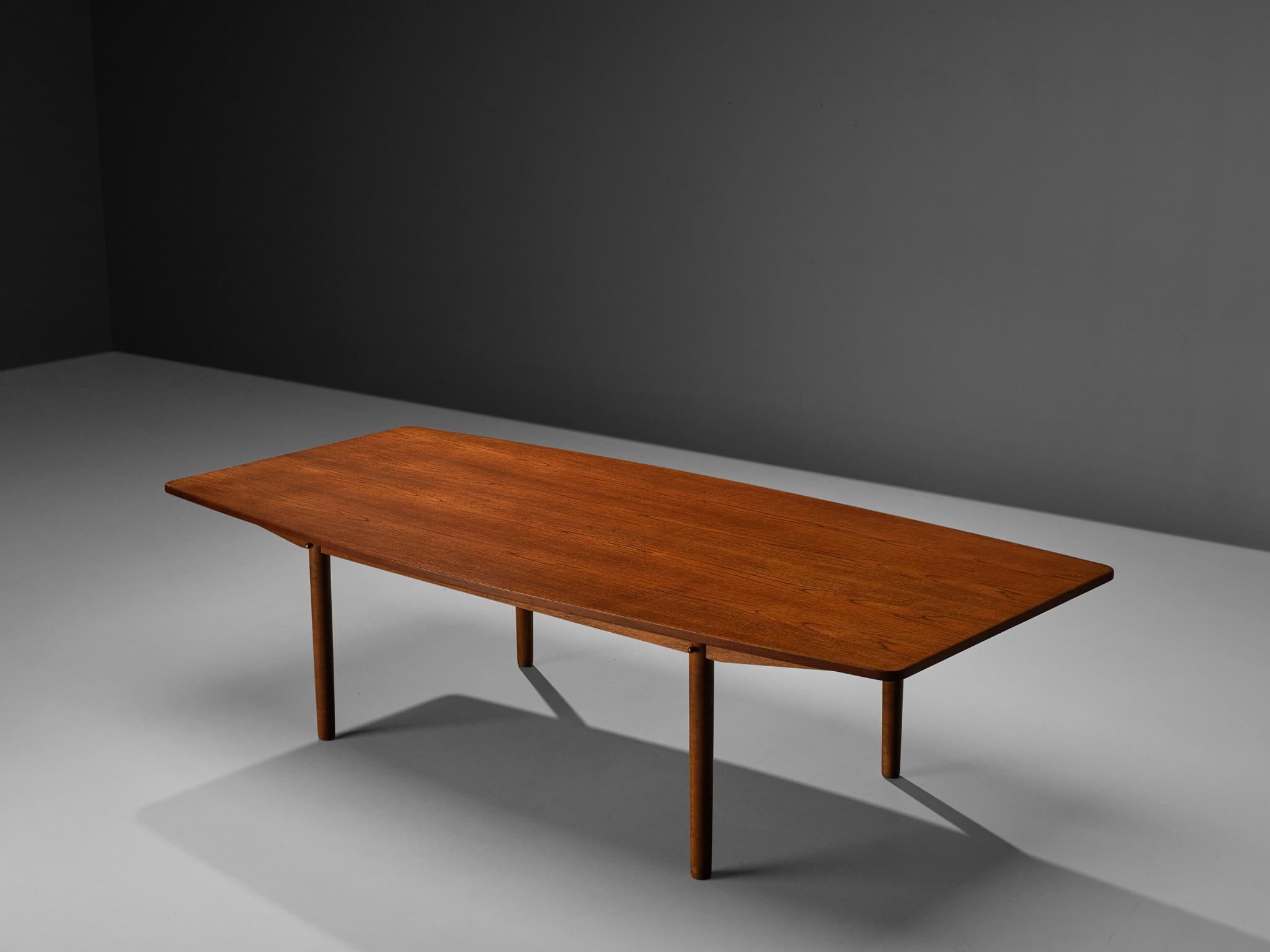 Danish dining table, teak, brass, Denmark, 1950s

This dining table was designed and manufactured in Denmark in the 1950s. The rectangular shape of the top widens at the long sides, therefore a boat-shape is evoked. This feature but also the rounded