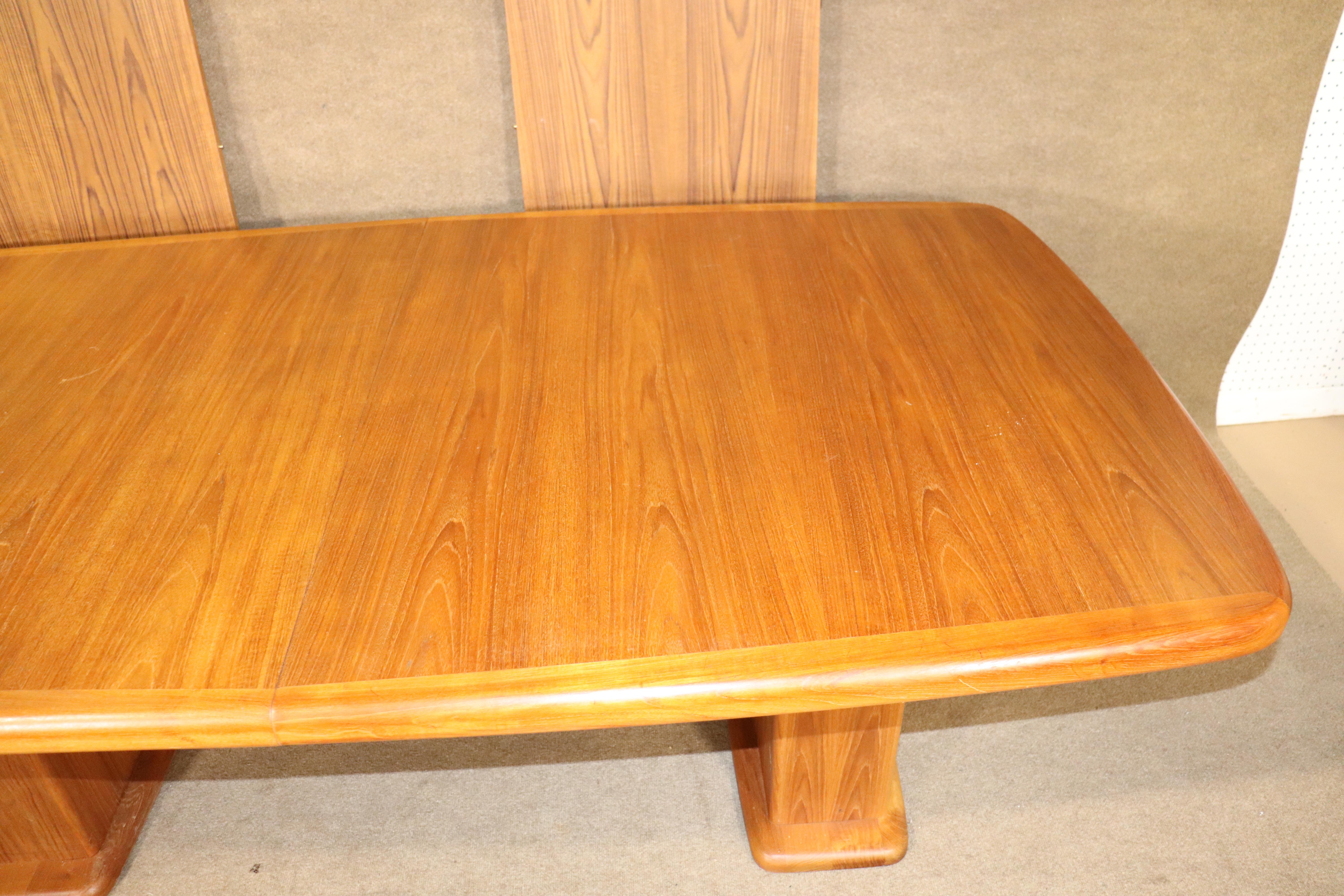 Mid-Century Modern dining table in teak wood grain. Danish made with two 21.75