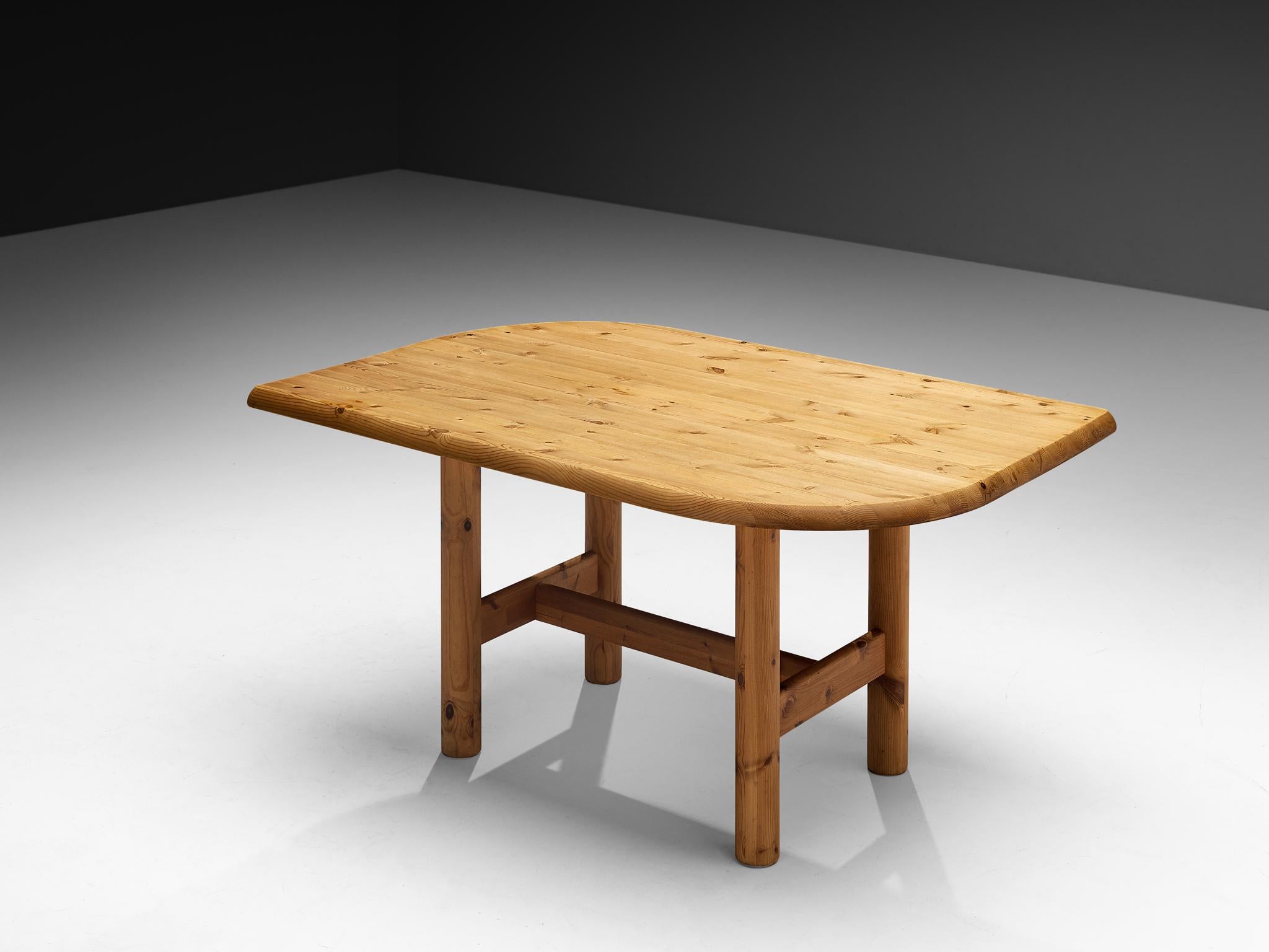 Dining table, solid pine, Denmark, 1970s

A stunning dining table executed in a solid pine with beautiful color and visible grain. The table top has two rounded and two pointed edges, that meet each other diagonally. The shape of the table top