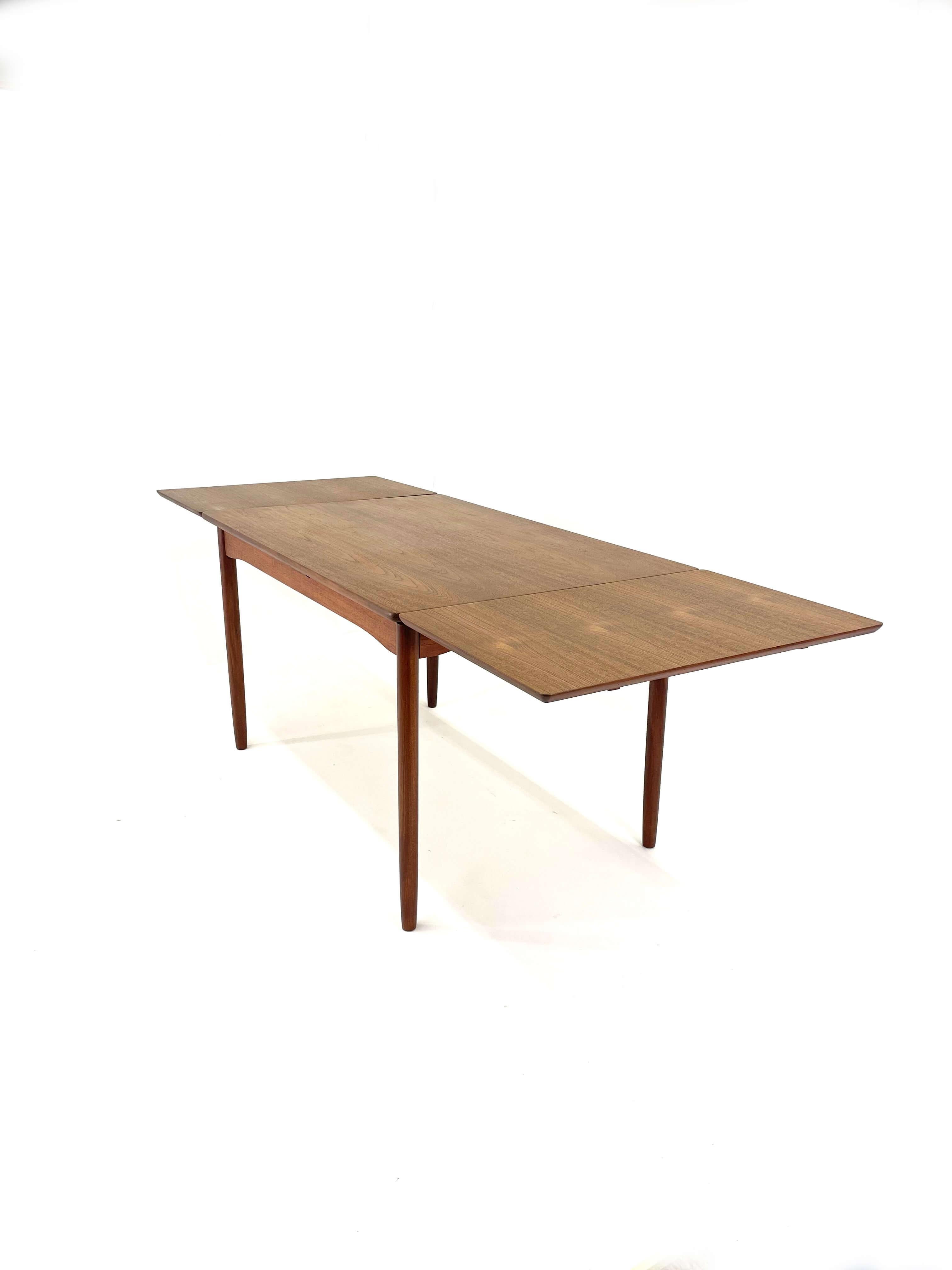 This is a lovely and classic Danish Modern Drawer Leaf Table in Teak and Afromosia. We have restored this to great vintage condition. This is a wonderful kitchen table. it is made for a small family. It is unfussy and simple but great quality. This