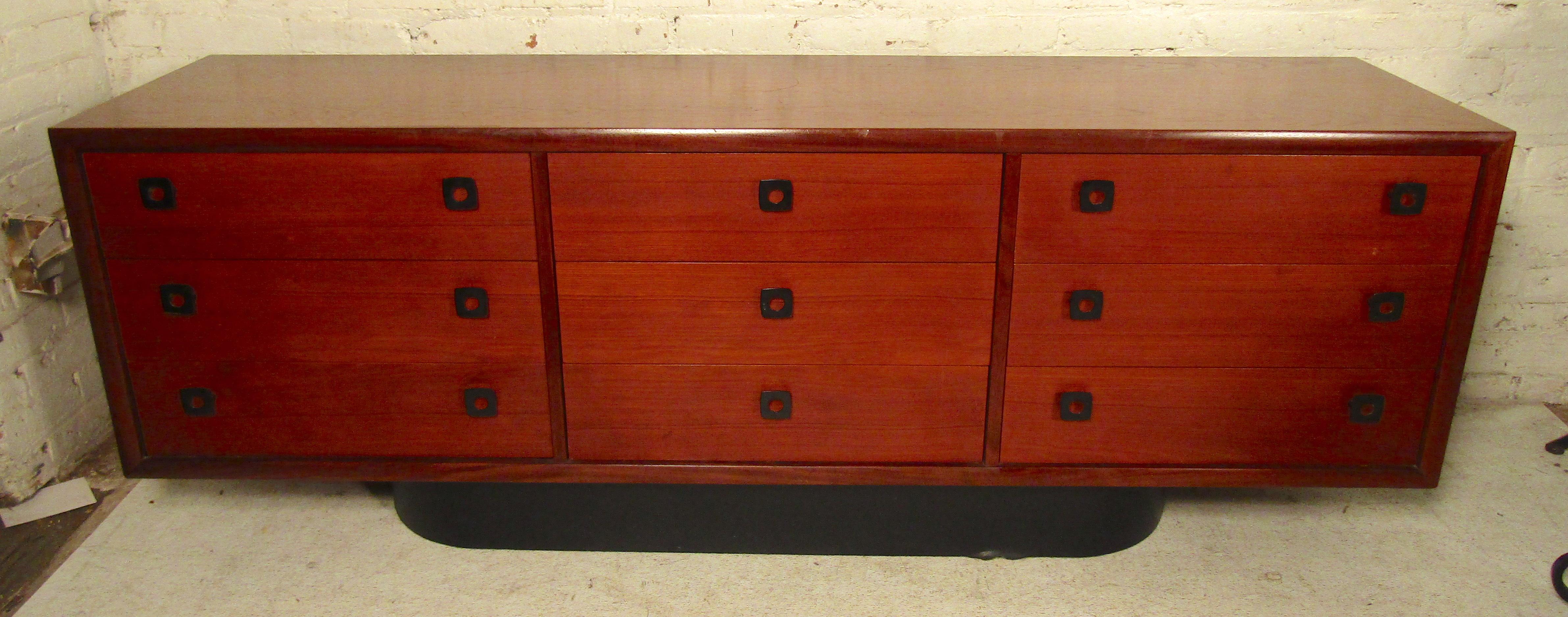 Long teak dresser with black pulls and matching rounded base. 
(Please confirm item location - NY or NJ - with dealer).
    