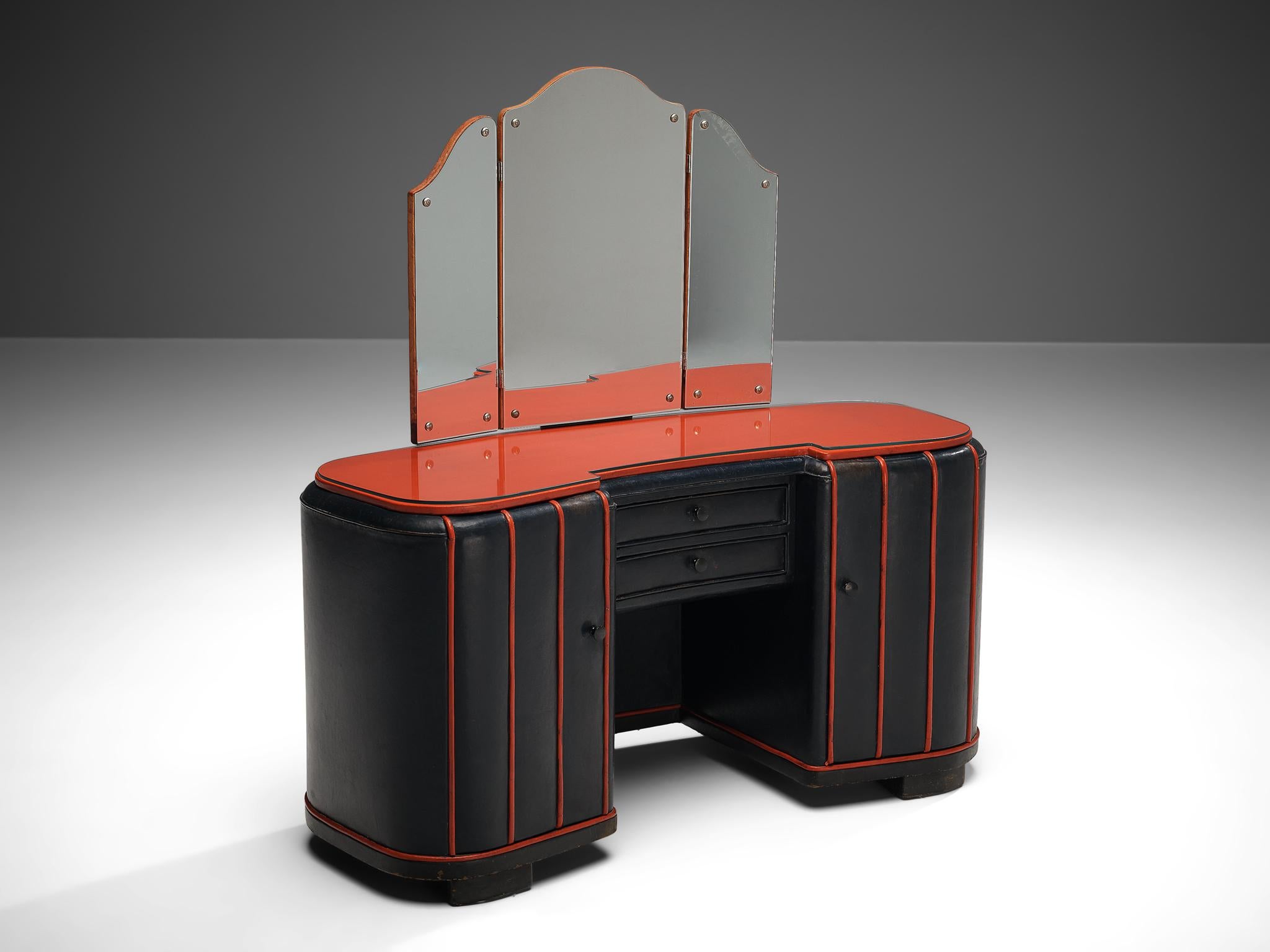 Dressing table, leather, glass, wood, Denmark, 1940s.

With a dark blue leather surface with red lines this dressing table has a rare texture and appearance. The front with two storage compartments and drawers in the center is topped with glass on a