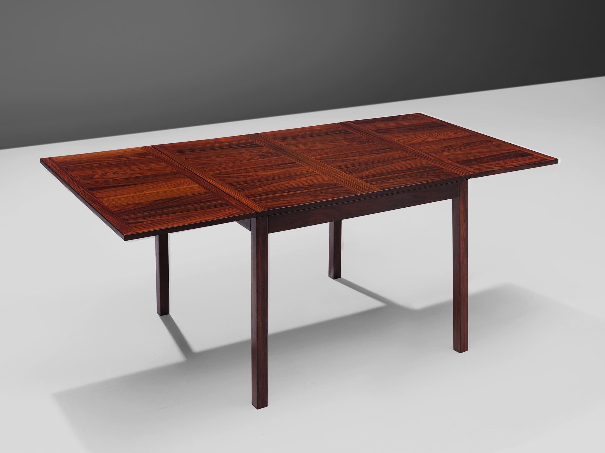 Vejle Stole Møbelfabrik, extendable dining table, rosewood, Denmark, 1960s

This Danish dining table is modest in shape and aesthetics. Yet the table is solidly executed and features a geometric inlay on the top. The legs of the table a completely