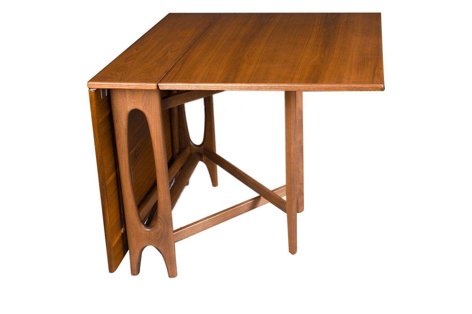 A Teak drop leaf expandable gate leg dining table in the manner of Bruno Mathsson. An exceptional work of Danish craftsmanship. This is an outstanding selection for serious collectors of mid century modern Danish. The leaves hang from the table,