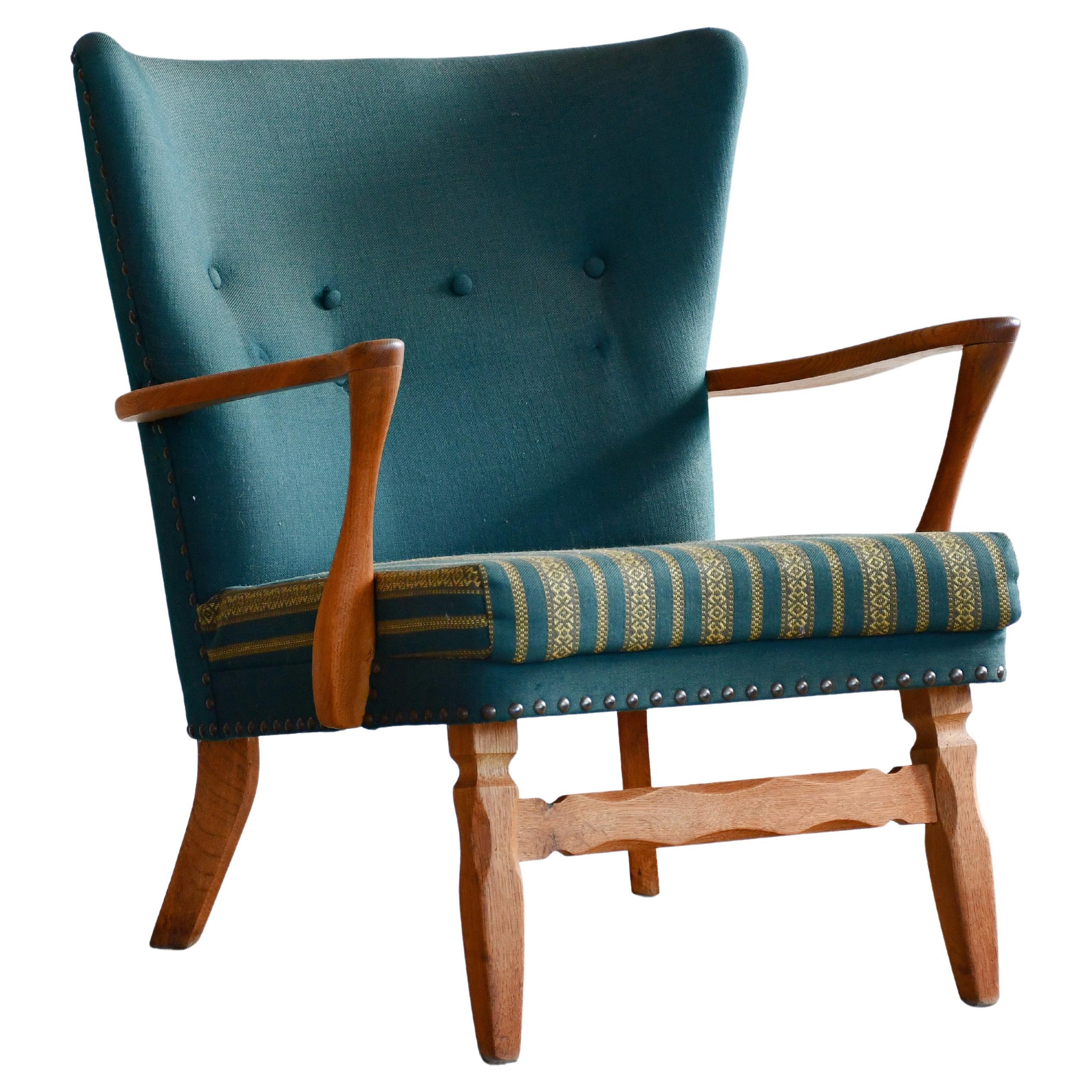 Danish Easy with Carved Oak Base and Armrests attributed to Henning Kjærnulf For Sale