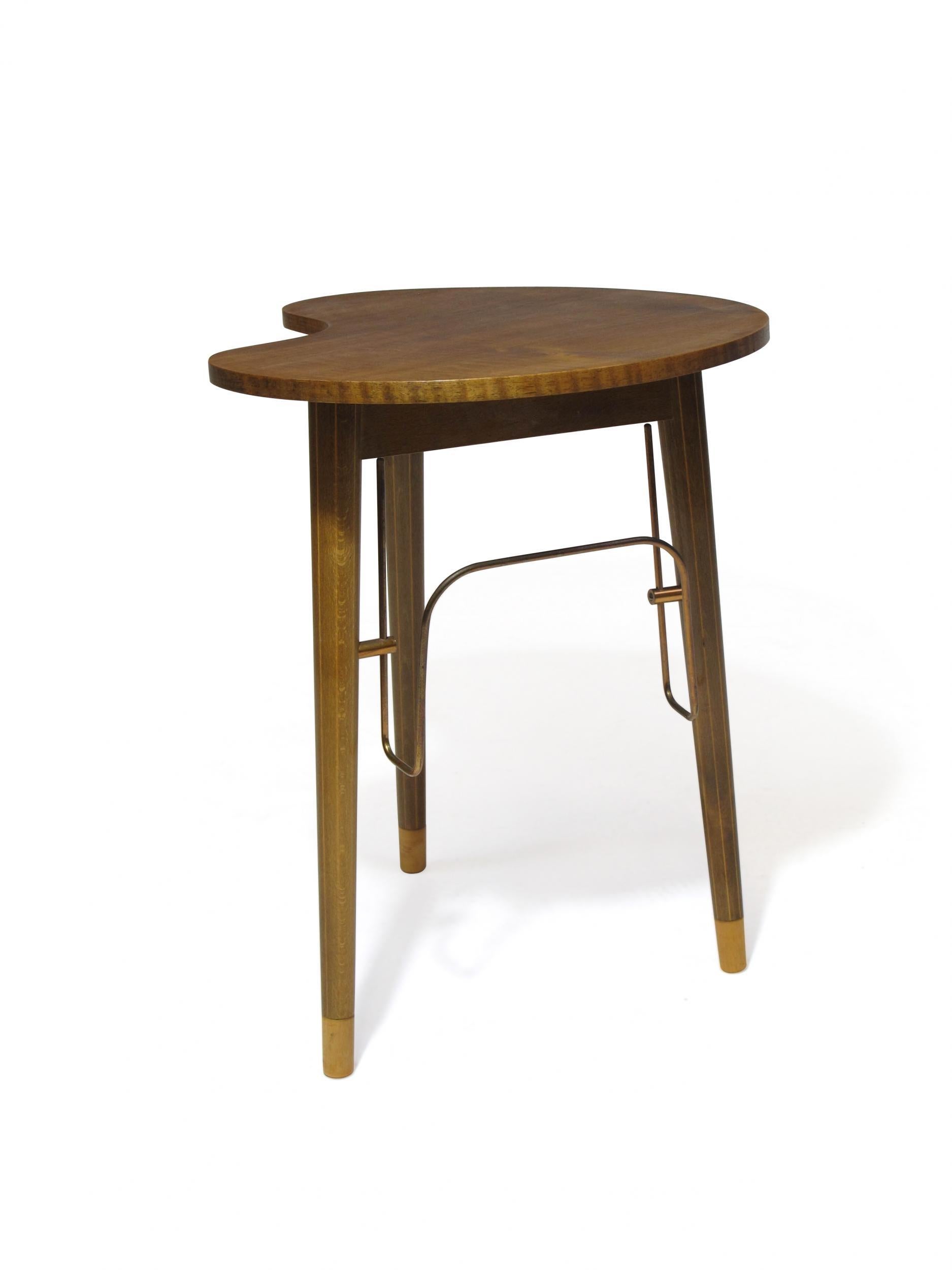 Danish mid century side table designed by Edmund Jørgensen for Gorm Moblefabrik, circa 1950 Denmark. The side table crafted of walnut top with a copper magazine holder, hidden ashtray, raised on tapered legs.