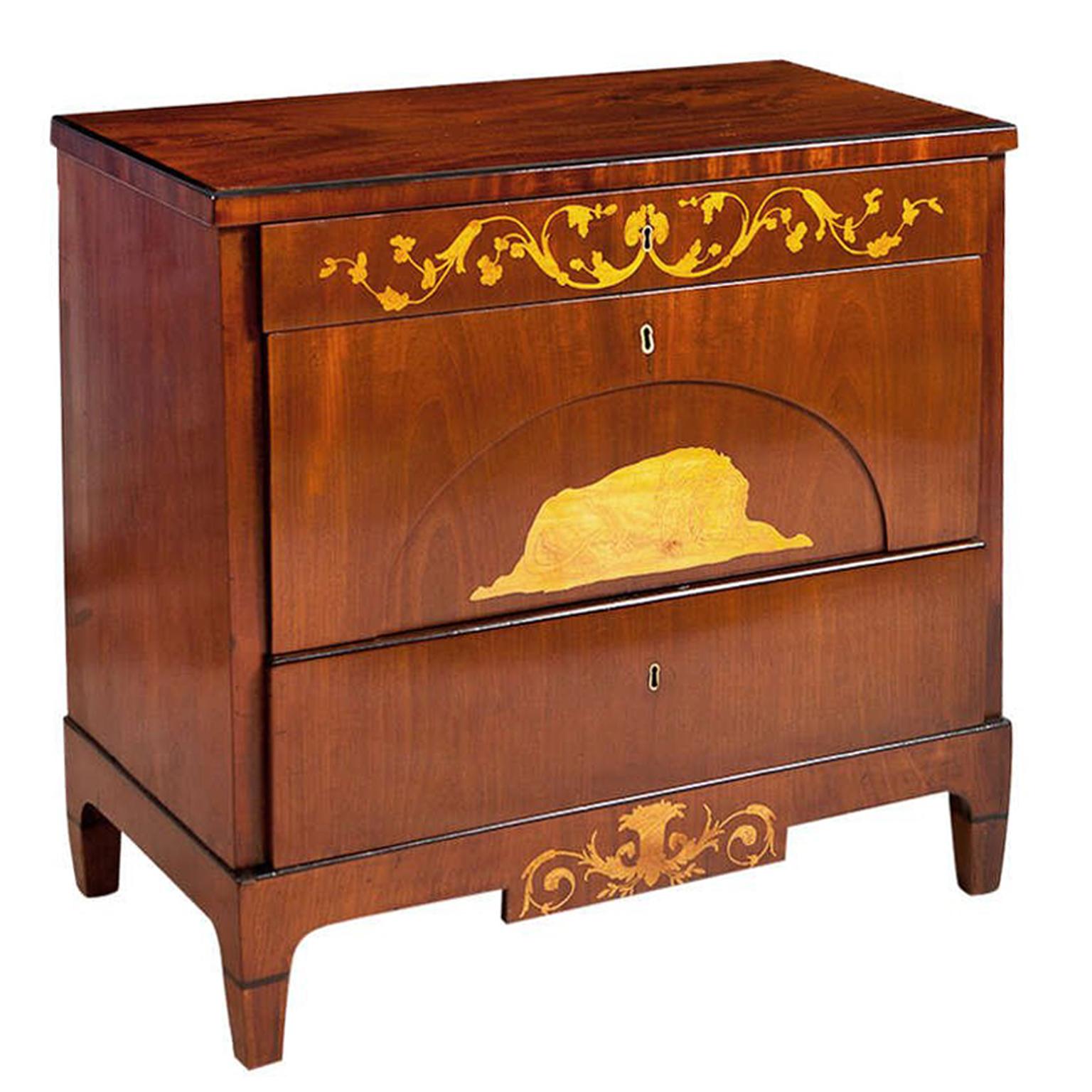 A very lovely Empire chest with three drawers in mahogany with satinwood inlays of resting lion and foliage. Denmark, circa 1815. This uniquely Danish design in regard to scale, proportion and style has a fresh and Classic feel. The inlays are