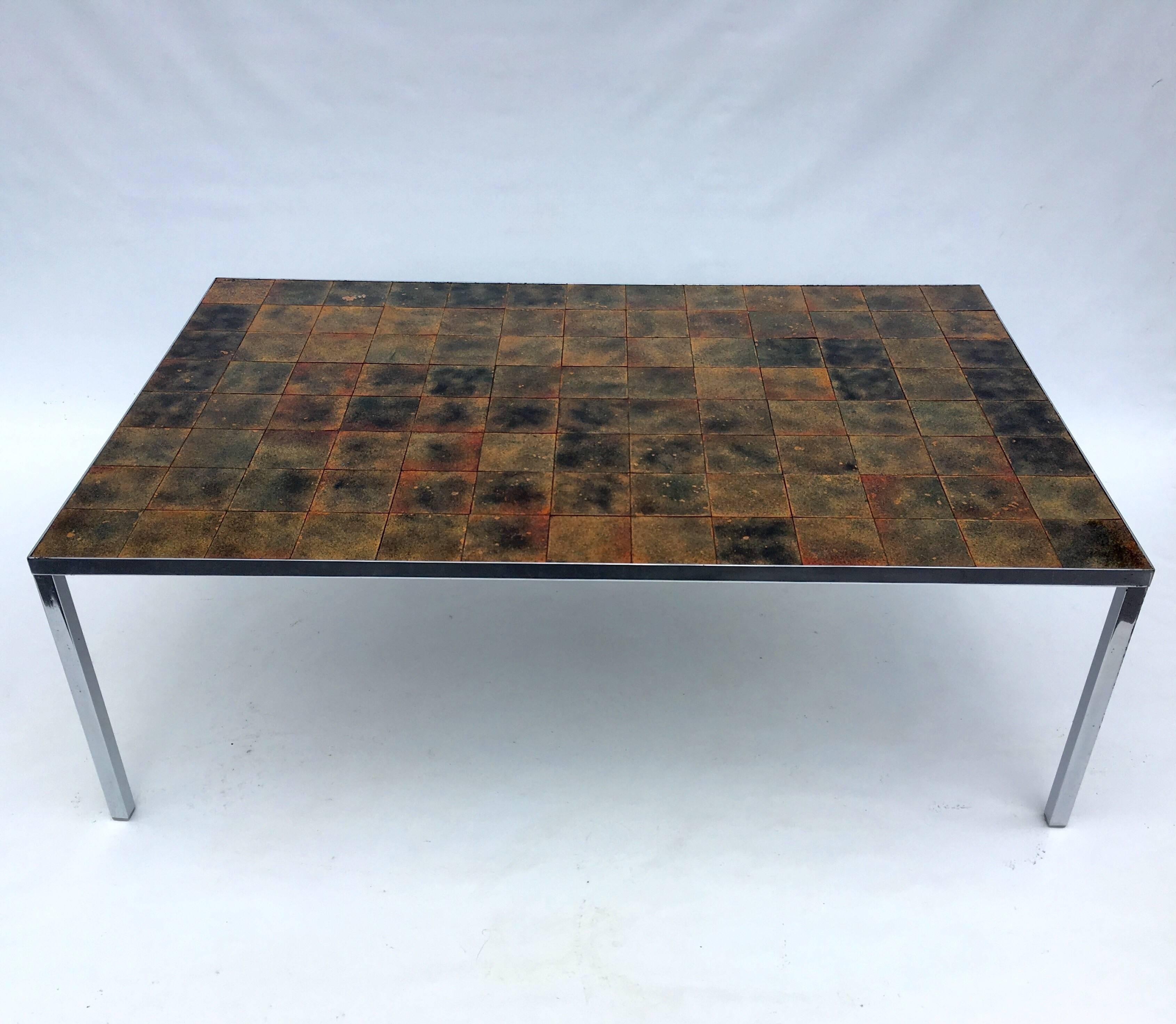 Interesting signed Danish coffee table. Chromed base with an enameled copper tile-top.