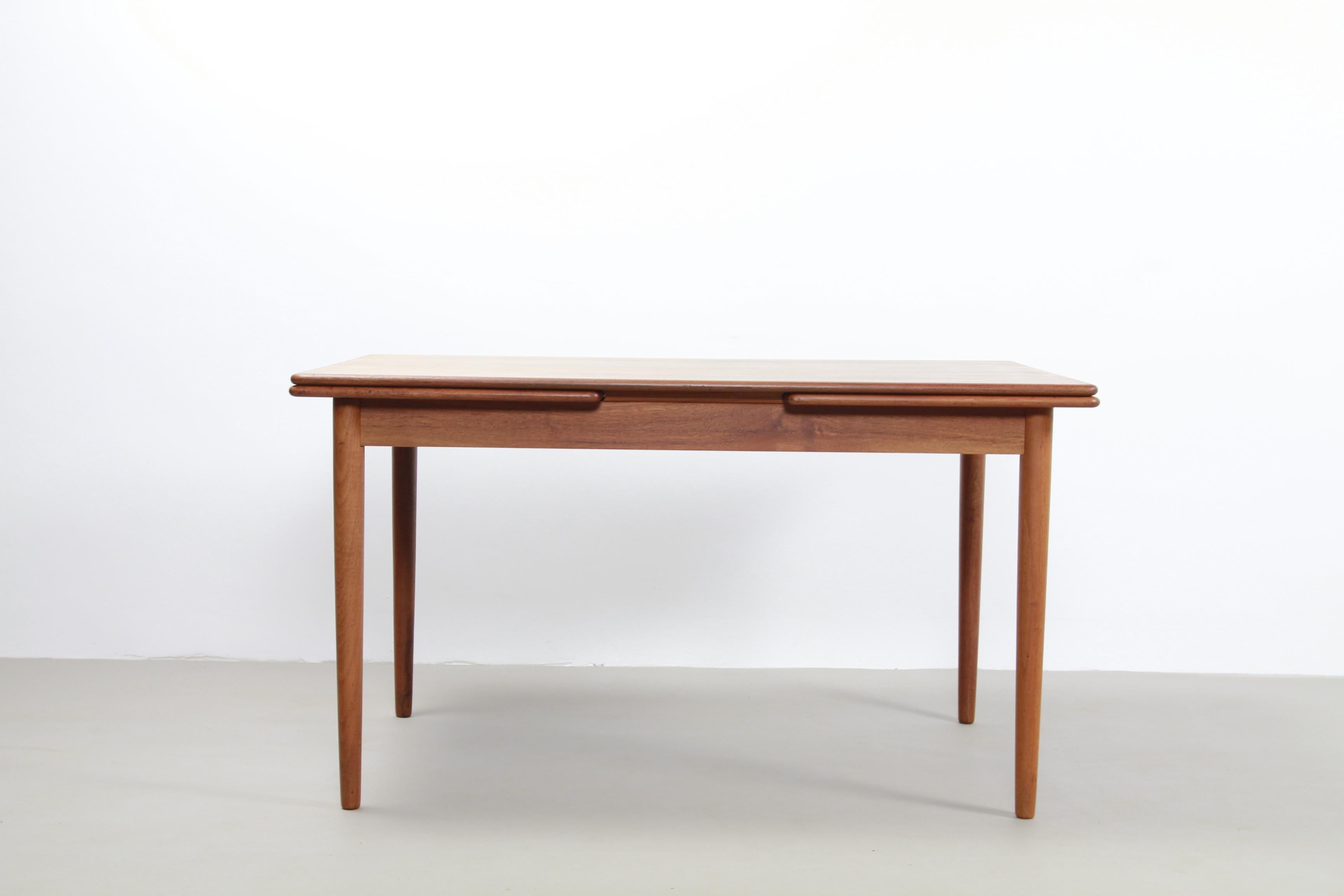 Vintage Danish extendable dining room table in teak.
The two extra leaves are nicely integrated into the design, stored under the top, so that the table is both folded and unfolded a beautiful piece to see. We have purchased this table together