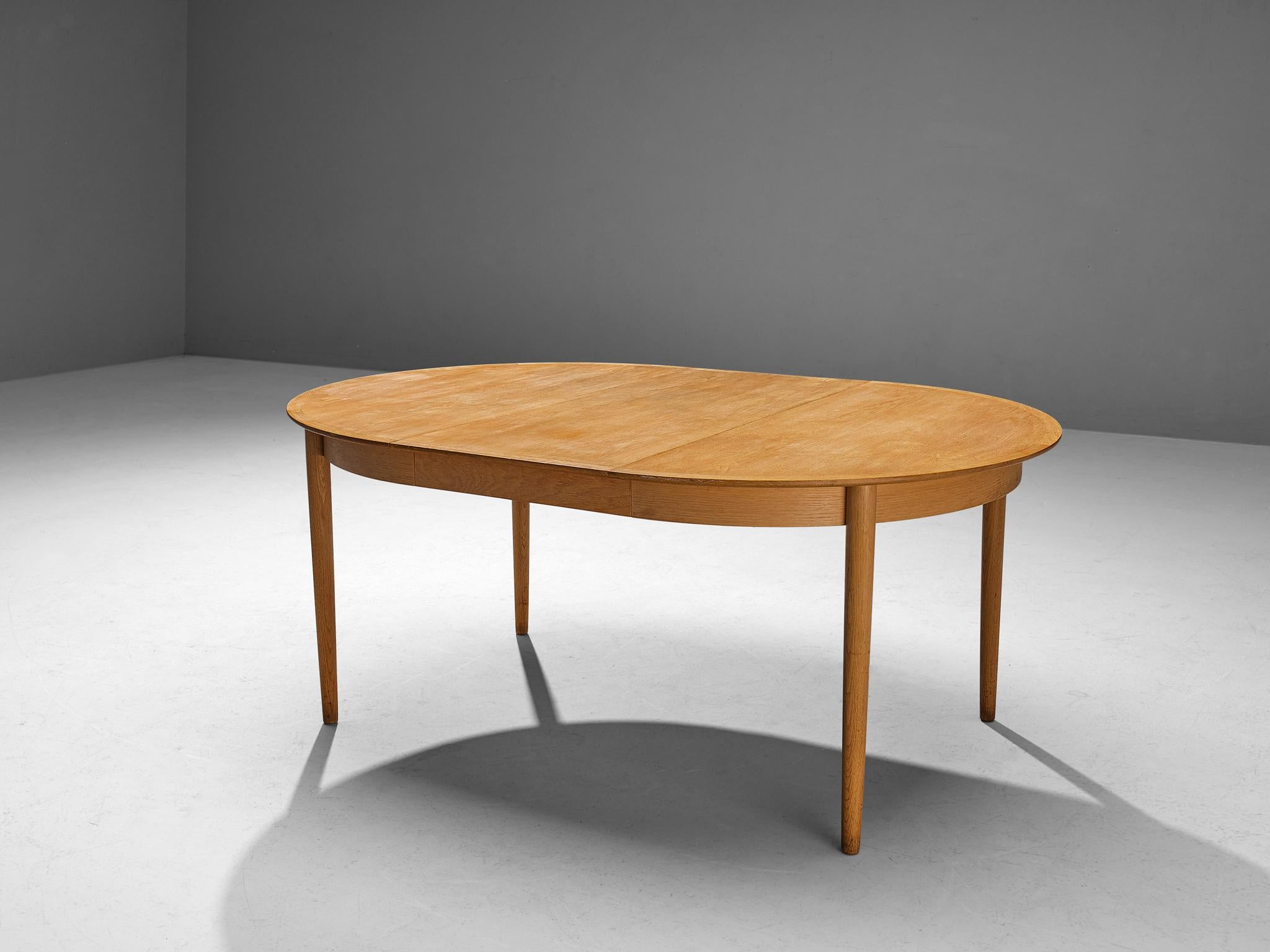 Dining table, Denmark, oak, 1960s

Lovely and elegant Danish extendable round dining table. The tabletop exists of two parts, where either one- or two additional extension leaves can be placed to create a larger table. The table is made in a very