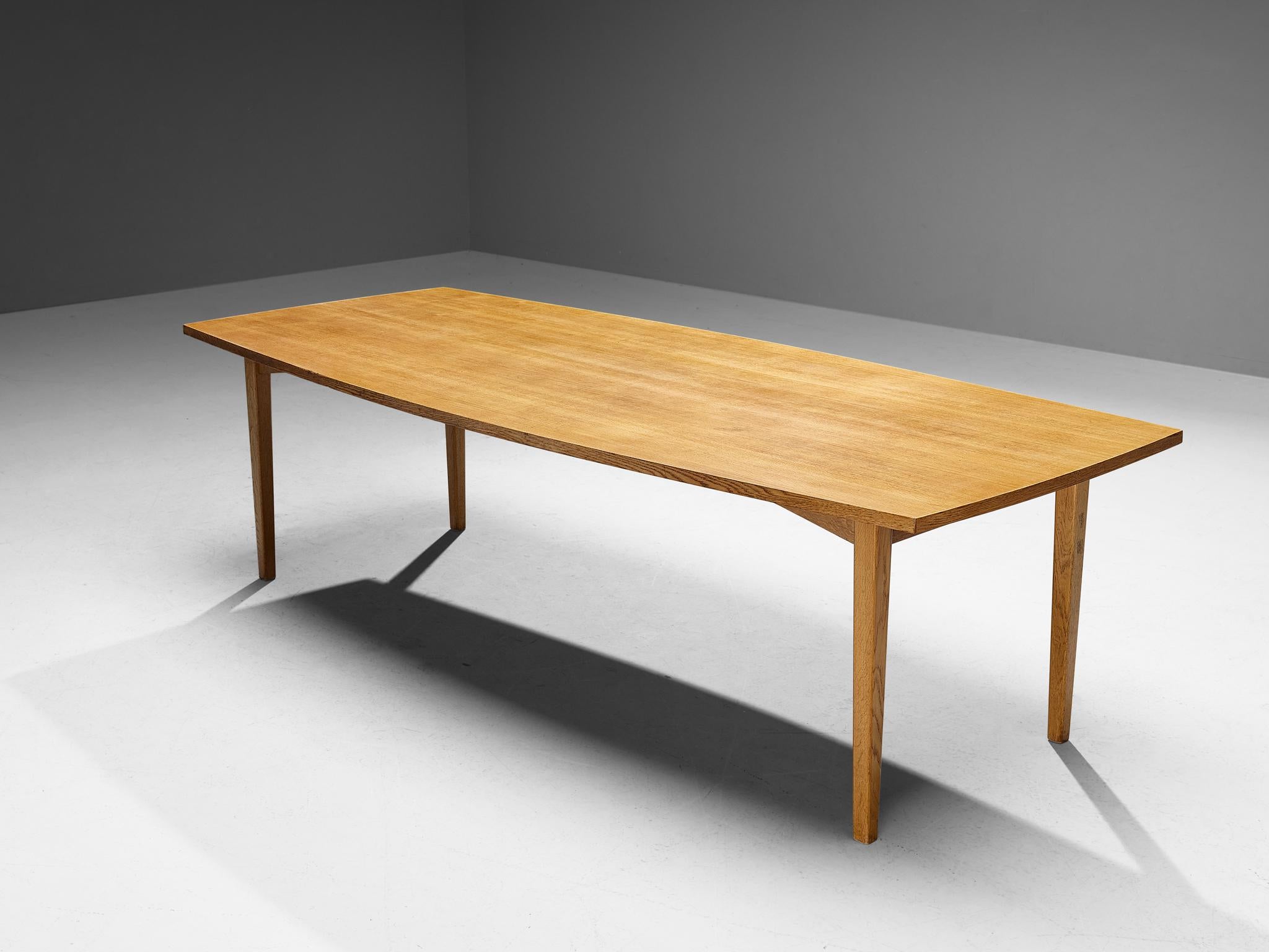 Extendable dining table or conference table, oak, Denmark, 1960s 

A sizeable dining table or conference table executed in oak. On each side, a leave can be attached to the frame which allows the user to enlarge the surface of the table. The base