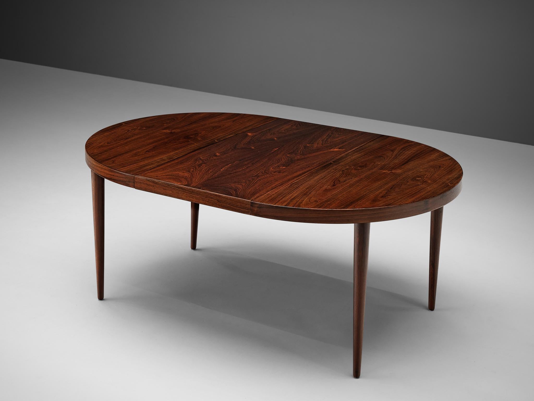 Extendable dining table, rosewood, wood, Denmark, 1950s

This round dining table features a leaf to extend its seize. Therefore, the table is adjusting to different situations. The rosewood tabletop shows striking grain that adds a natural tough to