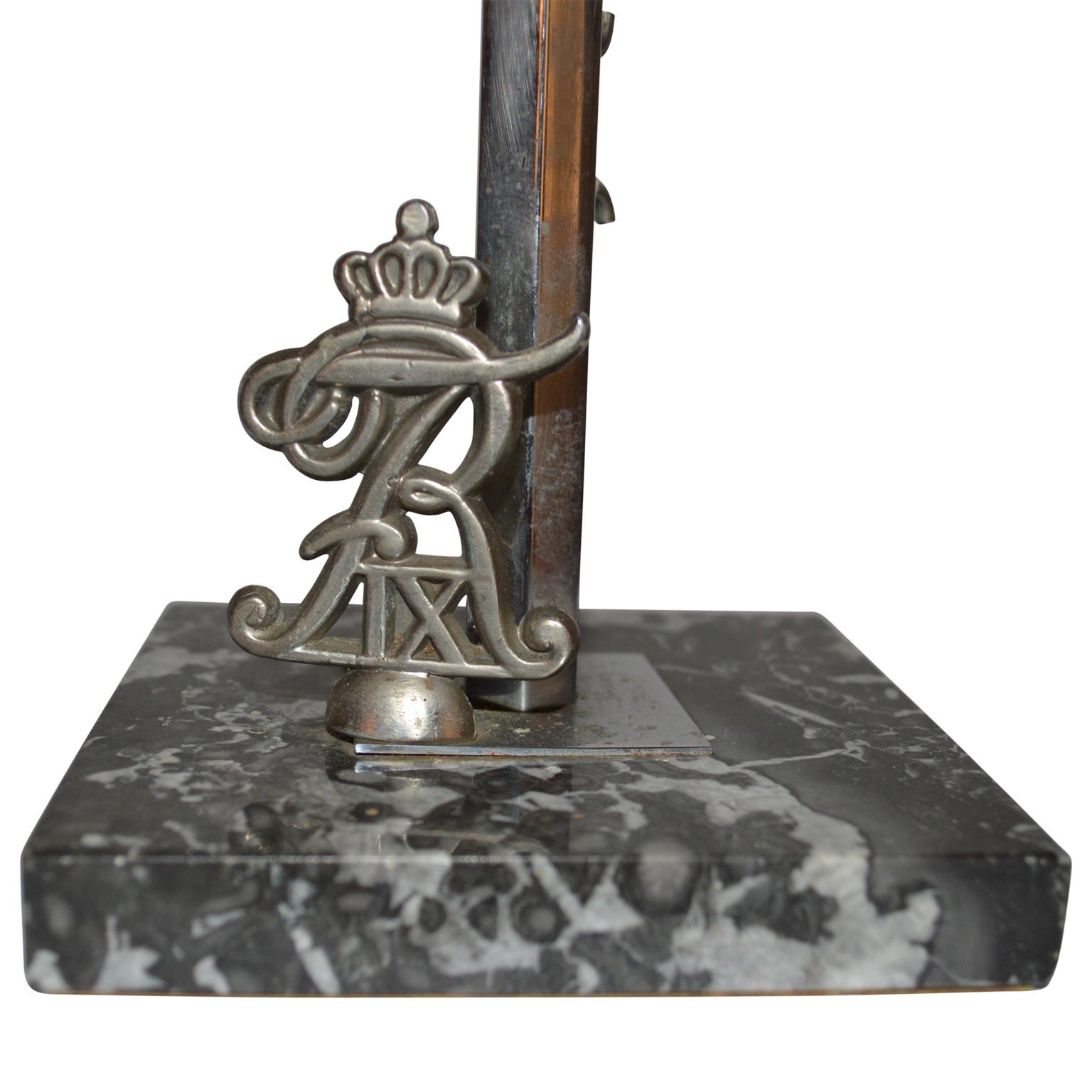 Danish flag post with Dannebrog on a marble stand with Royal Monogram of King Frederik IX.
The flag post is most likely made for the coronation of the King in 1947. Flag post is silver plated.
King Frederik IX, Born 1897, RIP 1972.
 
