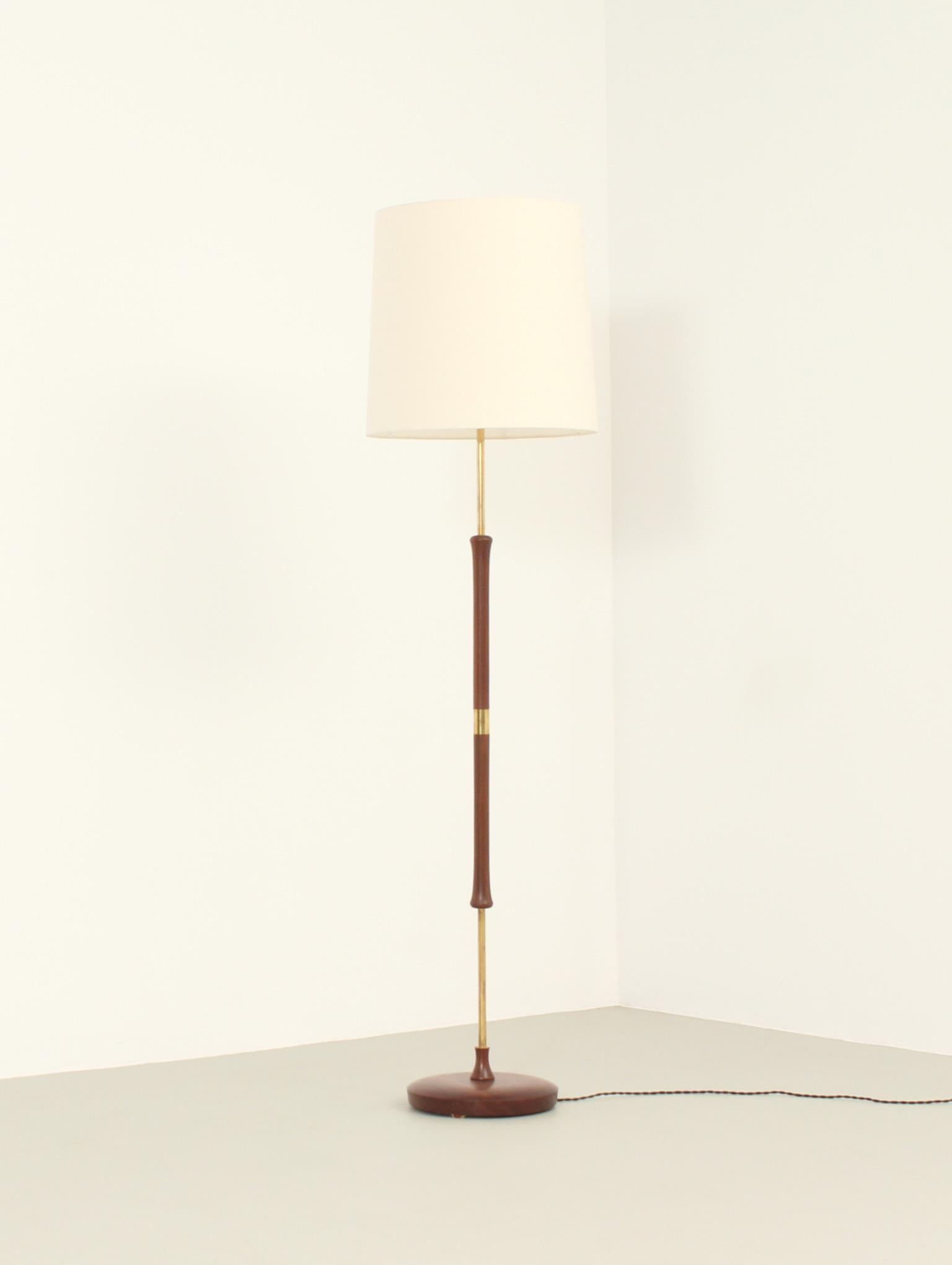 Danish floor lamp from 1950's. Teak wood and brass details and original shade with new fabric.