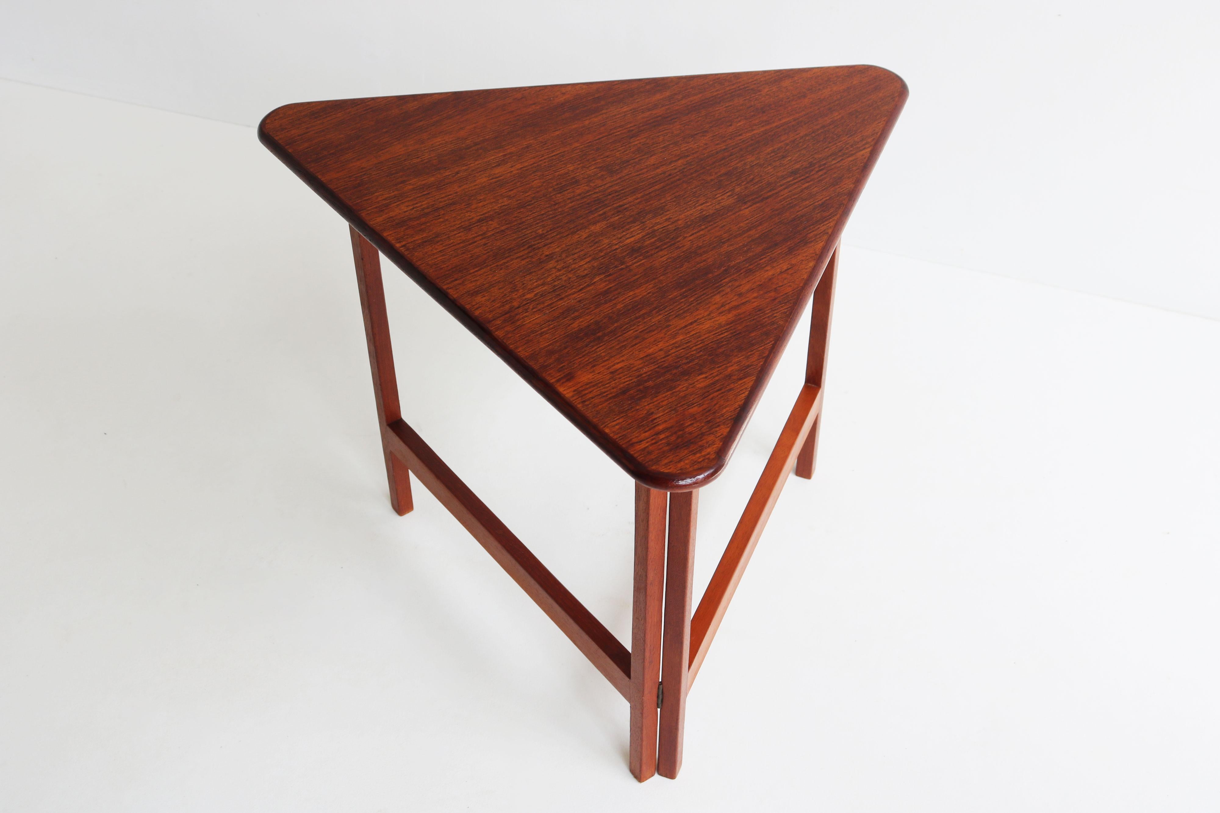 Rare & Unique! This Mid-century modern Danish design foldable triangular table by Illum Wikkelso for Silkeborg, Denmark circa 1960. 
Crafted from teak with attention to detail & a unique design that stands out. 
Folds with ease and pops into sturdy