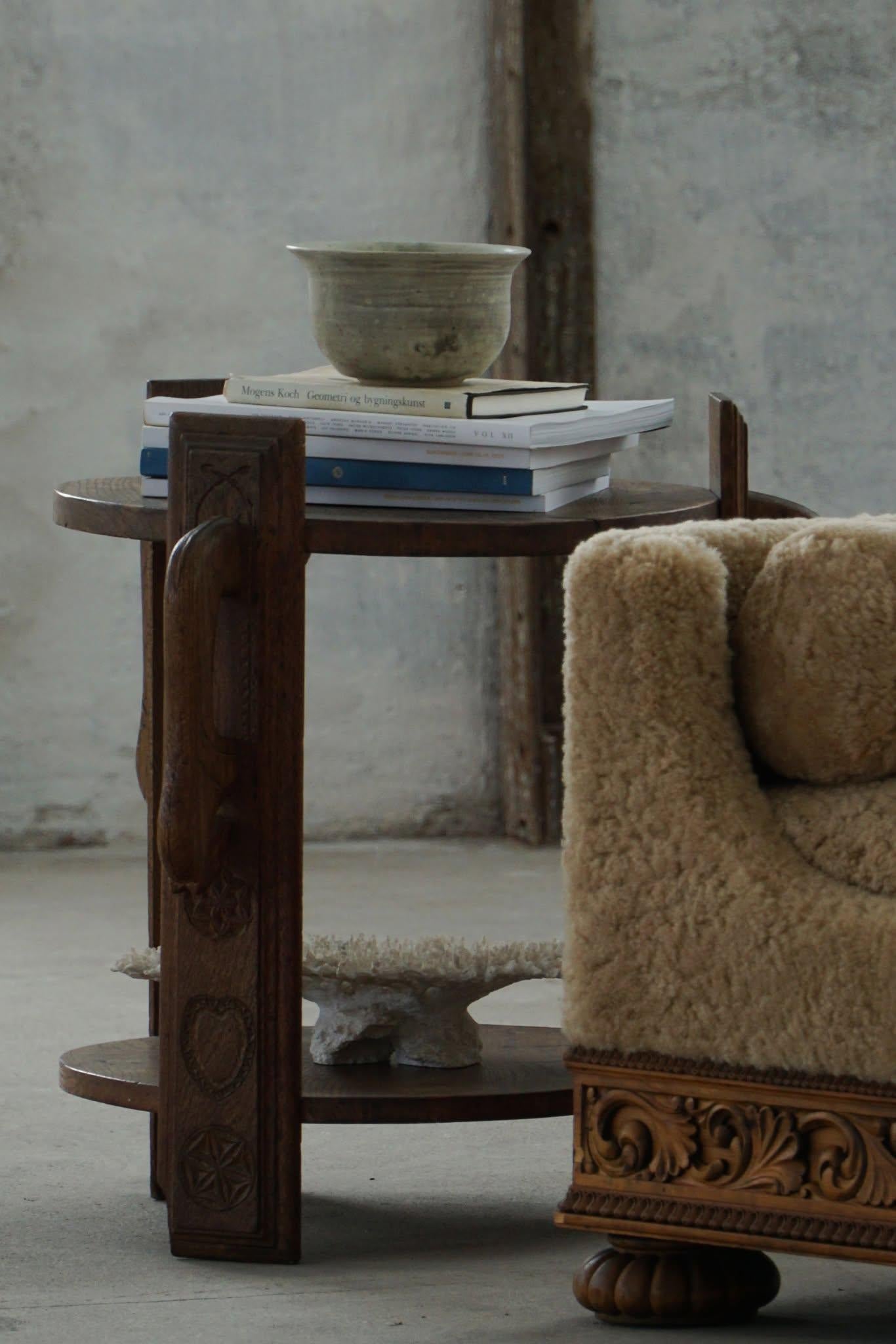 This Folk Art side table, made in Denmark and dating back to the early 19th century, is a striking example of rustic craftsmanship in the Wabi Sabi style. 

Carved from solid oak, the piece has a distinct character, while still retaining its