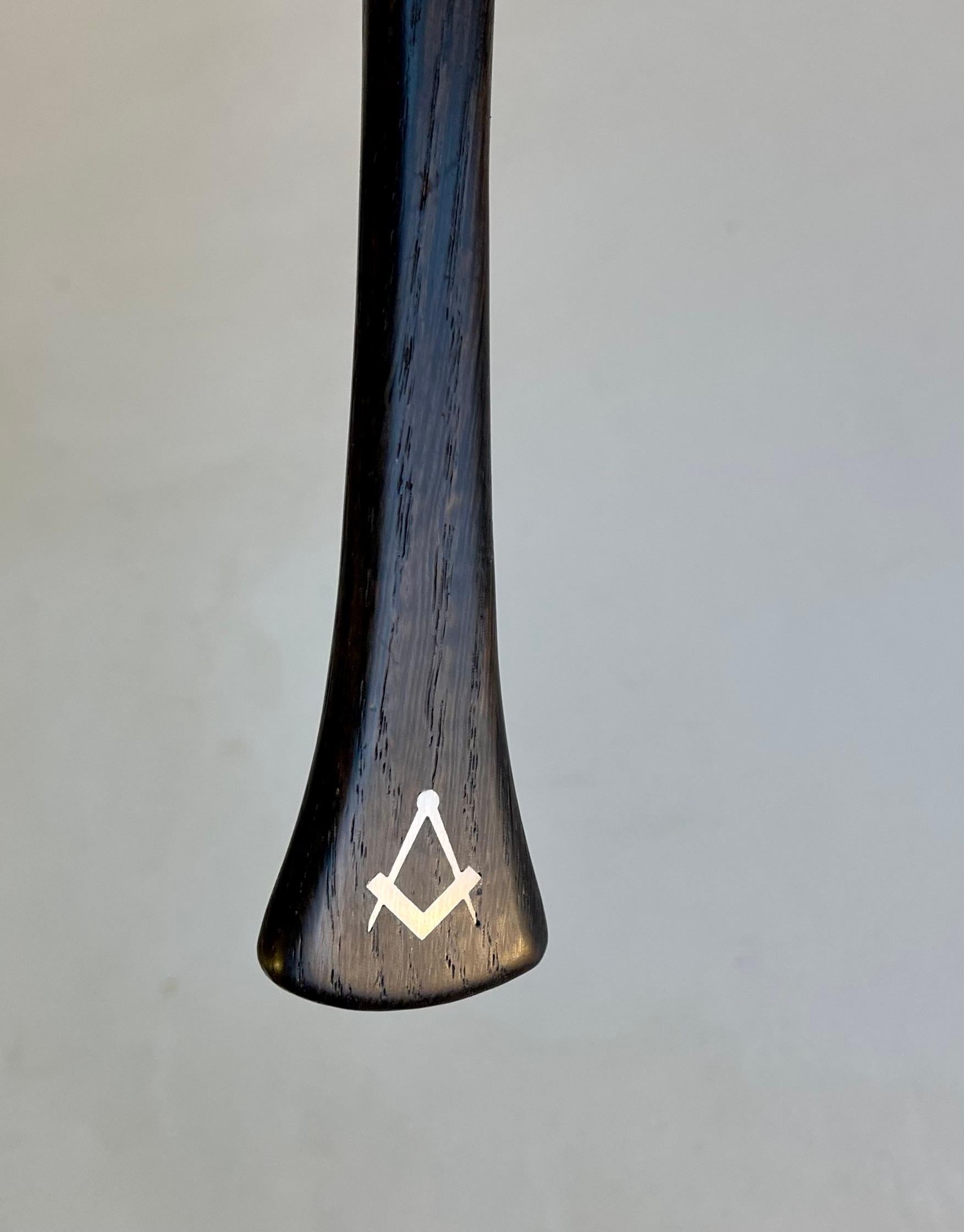 Hans Hansen bottle opener executed in plus 200 years old bog oak and inlaid with sterling silver. A number of 100 piece were ordered by the Danish Masonry society between 1950-60 hence the characteristic symbol to the handle. Measurements: L/H: 17