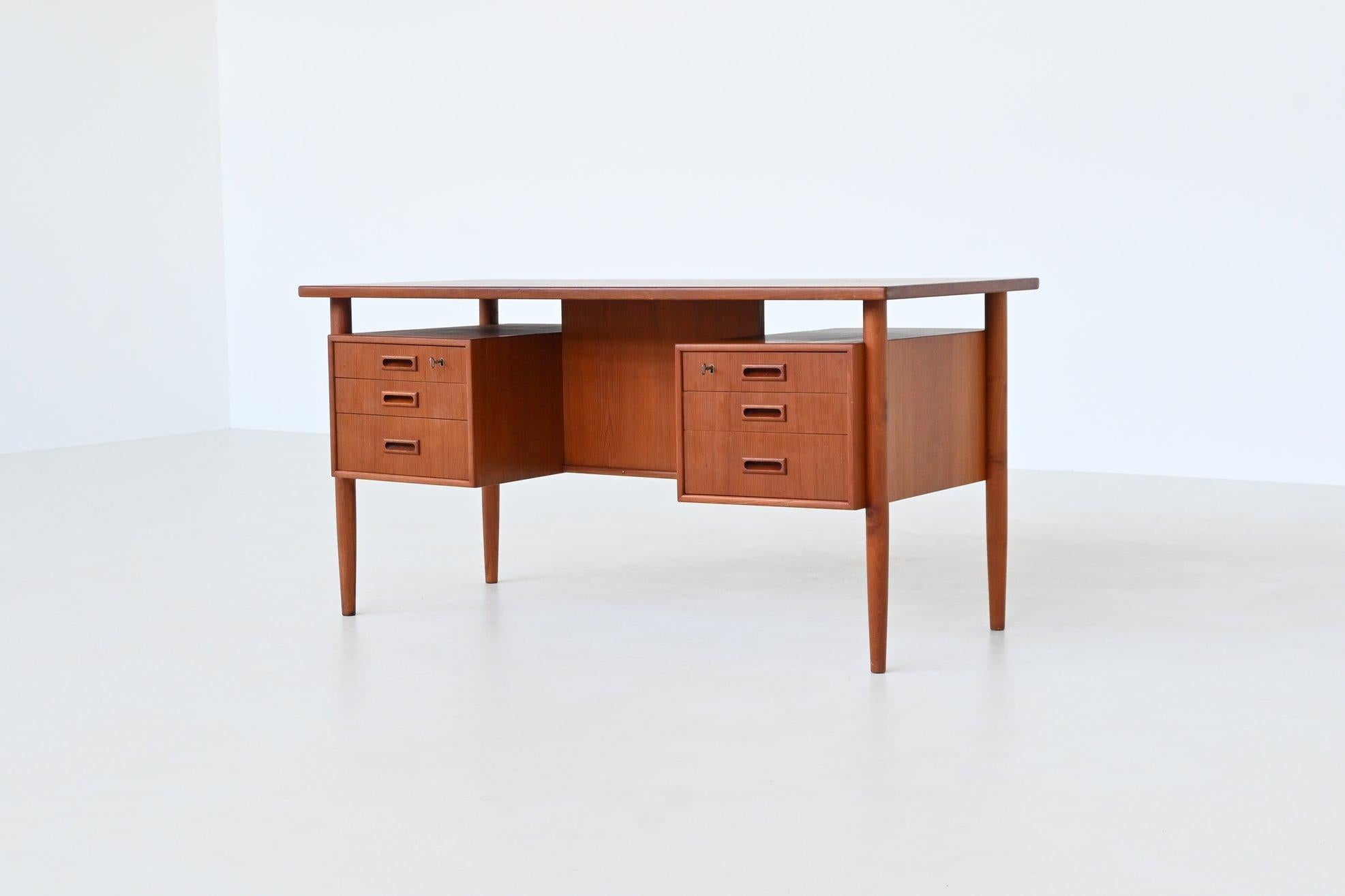 Beautiful freestanding writing desk in the style of Arne Vodder, HP Hansen and Arne Wahl Iversen, Denmark 1960. This desk is a superb representation of 1960s Danish craftsmanship. Constructed from rich teak wood, it features an exceptionally fine