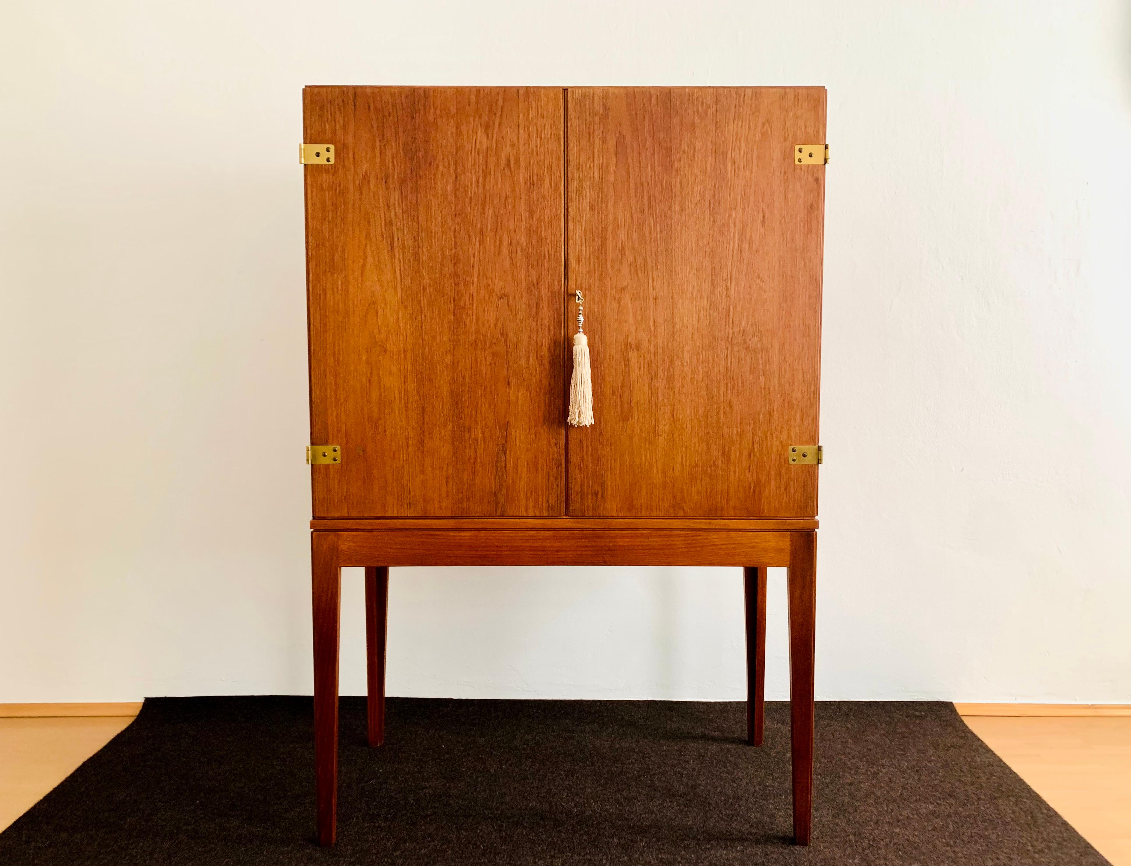 Exceptionally beautiful Danish teak bar cabinet or highboard from the 1950s.
The high-quality workmanship and the elegant design make the furniture a real favourite.
The highboard can also stand freely in the room.

Condition:

Very good